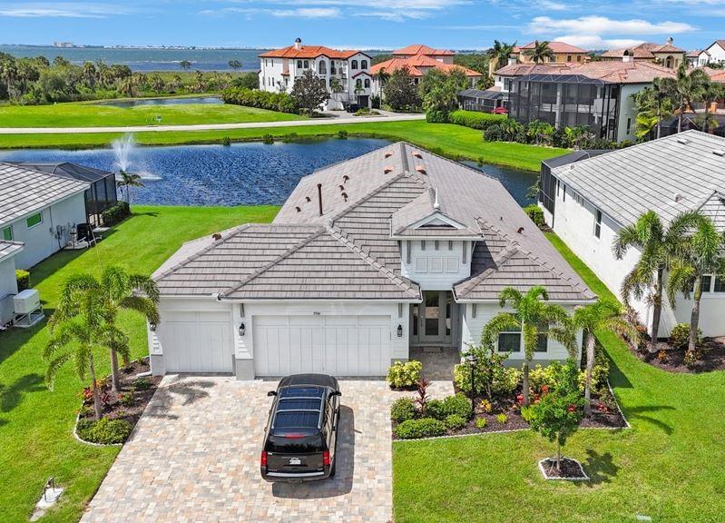 Discover refined, coastal, luxury living in this immaculate 4-bedroom, 3-bath residence located in the prestigious gated community of Legends Bay near Sarasota Bay. Built in 2022, this expertly designed home offers a sophisticated blend of modern elegance and coastal charm, featuring a breathtaking water view and a screened-in saltwater, heated pool with an expansive lanai ideal for outdoor dining and relaxation. The private primary suite is a true retreat, showcasing two walk-in closets, a double vanity, and an oversized double shower. Meticulously maintained and never impacted by hurricanes or flooding, this property offers both peace of mind with hurricane impact windows and refined comfort. Residents enjoy gated security and a prime location just minutes from IMG Academy, Sarasota Airport, IMG Golf Course, tennis courts, the pristine Gulf beaches, downtown Sarasota, fine dining, and shopping. Legends Bay features a picturesque lakeside clubhouse and pool, ideal for relaxing while taking in breathtaking sunsets. The property also boasts a scenic pier that extends through serene, protective mangroves, offering stunning views of Sarasota Bay. Schedule your private showing today!