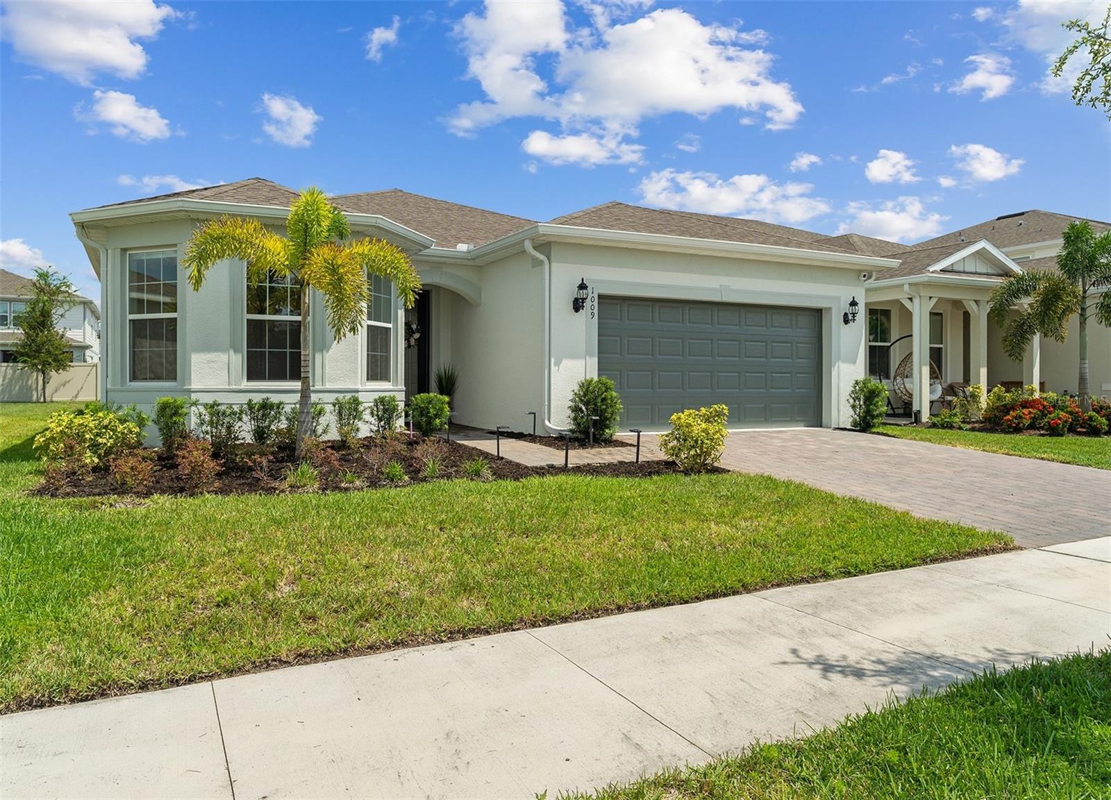 Wow!! NEWLY BUILT HOME (2023) in East Orlando with a front CONSERVATION/WATER VIEW! 3 bedrooms PLUS 4th FLEX SPACE OFFICE! From the moment you walk in, you’ll notice how well-maintained, fresh and clean this home feels! TALL CEILINGS & UPGRADED 8' TALL DOORS, OPEN LIVING SPACE, RECESSED/TRAY CEILING and GOURMET KITCHEN are among the many highlights! The gourmet kitchen features a MODERN FLAT COOKTOP with additional custom cabinetry, WALL OVEN & MICROWAVE, STAINLESS STEEL RANGE HOOD that vents to the outside. A LARGE PANTRY and QUARTZ countertop KITCHEN ISLAND is perfect for entertaining. This unique floor plan has one-of-a-kind ZERO CORNER SLIDING GLASS DOORS that open fully to connect your interior space with the EXTENDED COVERED LANAI. Both the lanai and front driveway are designed with PAVERS that give a timeless look elevating the curb appeal and easier maintenance. Enjoy a versatile BONUS 4th FLEX AREA next to the living room that can be easily converted to an OFFICE or 4TH BEDROOM by adding doors, or keep it open as a craft or playroom. The 2nd bathroom features a seamless bathtub surround shower that makes cleaning a breeze. The front bedroom has BAY WINDOWS showcasing a serene WATER AND CONSERVATION VIEW. You’ll love the extended LAUNDRY ROOM with extra cabinets and an additional storage room by the HVAC. Garage includes a TESLA EV charger. HOA INCLUDES HIGH SPEED INTERNET and FENCED PLAYGROUND down the street next to mature trees and open grass area for picnics and field sports. Conveniently located near HIGHWAY 408, this home is only a 10 min drive to WATERFORD LAKES TOWN CENTER, 15 min drive to UCF, and 25 min drive to DOWNTOWN ORLANDO and ORLANDO INTERNATIONAL AIRPORT. Don’t miss this chance to live in a brand new home that’s ready for move-in! SEE MORE OF THE HOUSE, WATCH THE VIDEO/VIRTUAL TOUR!