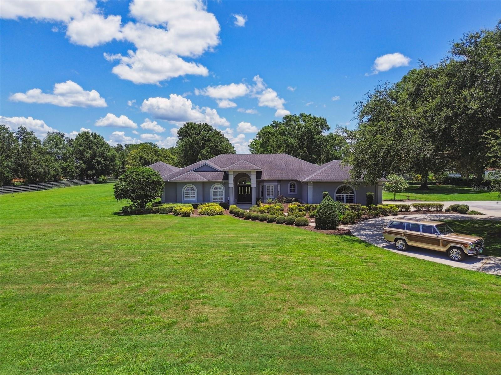Exquisite Equestrian Estate in the Heart of Odessa!!! Welcome to an extraordinary 5-acre equestrian retreat known as "Bare Foot Acres" offering a rare blend of luxury living and world-class functionality in one of Odessa’s most sought-after locations. Meticulously designed and impeccably maintained, this property is a dream-come-true for both discerning homeowners and horse enthusiasts. The expansive residence boasts 5 bedrooms, 4 full bathrooms, a dedicated office, and a thoughtful split-bedroom layout featuring two primary suites—ideal for multigenerational living or guests. Soaring ceilings, upgraded flooring, and top-of-the-line mechanical systems complement the chef’s kitchen, which is outfitted with professional-grade appliances, abundant custom cabinetry, and high-end finishes throughout. Enjoy seamless indoor-outdoor living with multiple living and entertaining spaces, including a stunning saltwater heated pool and spa, travertine decking, and a luxurious outdoor kitchen complete with a full bath and generous covered lounging areas. Equestrians will appreciate the three barns, including a main 10-stall barn and a secondary 2-stall barn, along with six fully irrigated and fenced pastures, designed for optimal grazing and safety. Every inch of this property reflects unparalleled attention to detail, comfort, and craftsmanship. Whether you're looking for a private oasis, an elite horse property, or a legacy estate—this one-of-a-kind Odessa treasure delivers. Come see what makes this estate feel like home, schedule a visit today! Well pump replaced July 2025.