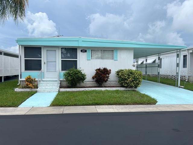 Don't miss the opportunity to live in the highly sought after, resident-owned, Lake Highlander Mobile Home Park in Dunedin. This well-maintained 1976, fully furnished single-wide with addition has 2 Bedrooms and 1 bath plus bonus Florida room and is ready for you to move in. Located on a very quiet dead-end street with no through traffic. New sub and laminate flooring throughout. Bathroom remodeled with new shower, toilet, vanity and flooring. Bedrooms have built-in dressers with two closets in each room. Living room has a sectional with recliners and includes a pull-out bed. Entertainment center with electric fireplace. Kitchen with newer refrigerator and glass top stove. Washer & dryer are in the utility shed. Deep carport which allows for two vehicles and golf cart too. Roof maintenance was done in 2024 and 4-point inspection in 2023.
Friendly 55+ community offers a geothermal heated pool, clubhouse with billiard and game room, spacious lanai, shuffleboard, laundry facility and a beautiful lake. LOW monthly HOA fee of $255 and includes water, sewer, trash, lawn-care, and all park amenities. Pet Policy: 2 indoor cats only, no dogs (unless service or ESA).
Lake Highlander is a golf-cart community and close to downtown Dunedin which offers plenty of shops and restaurants as well as walking and bike riding options on the popular Pinellas Trail.