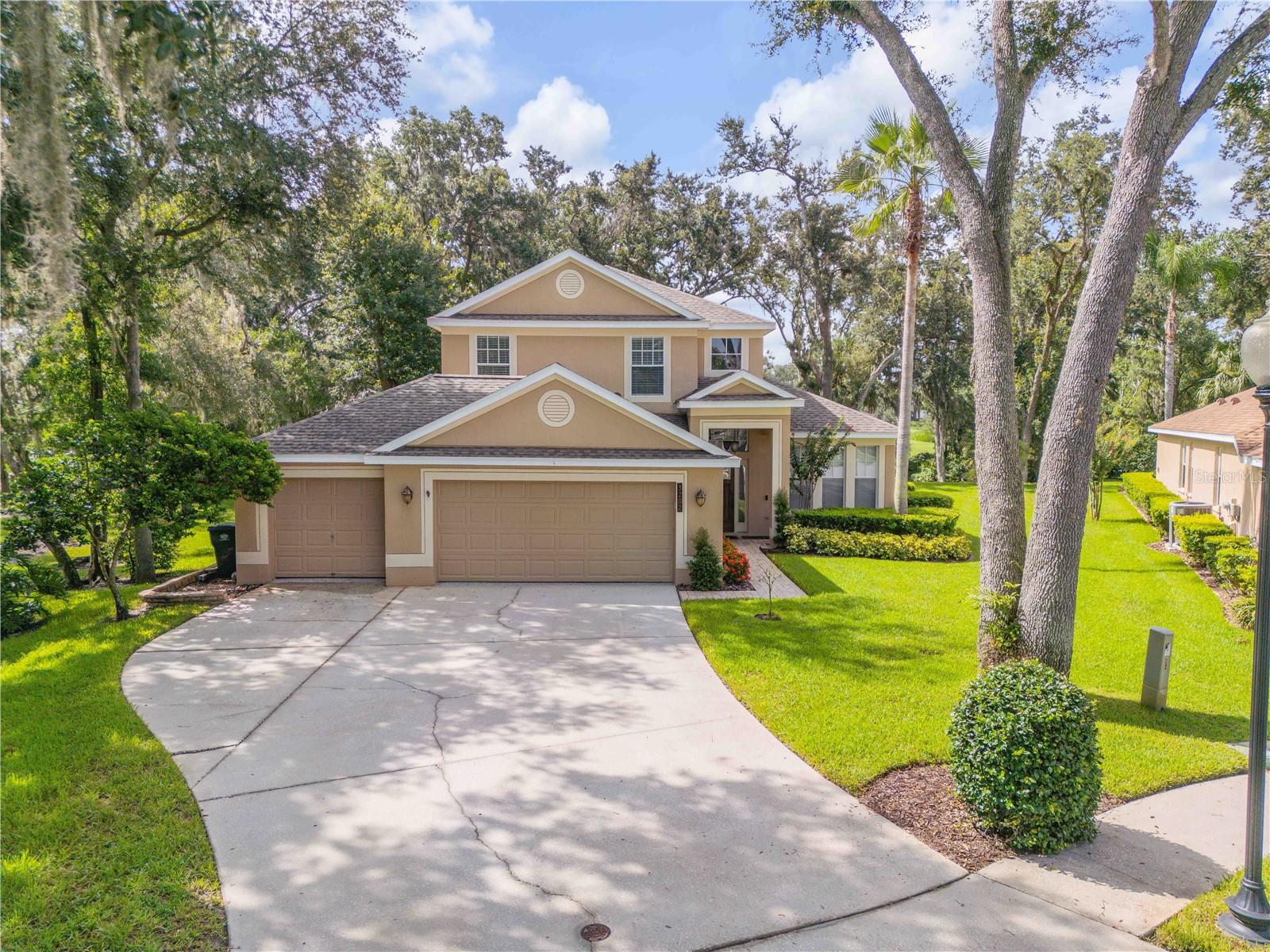 Welcome to your private retreat on a third of an acre, perfectly positioned on the iconic 14th “Signature Hole” of River Hills Country Club in Valrico. This 4-bedroom, 2.5-bath home with a 3-car garage featuring epoxy flooring and a spacious loft/bonus room sits at the end of a quiet cul-de-sac, offering privacy and sweeping golf course views. The open layout features a soaring foyer, formal dining with a pass-through to the kitchen, and a great room that flows seamlessly into the chef’s kitchen with stainless steel appliances, hardwood cabinetry, and a large island with breakfast bar seating. The first-floor owner’s suite includes dual walk-in closets and a bathroom with granite countertops, double sinks, a seamless glass shower, and a private water closet. Upstairs are three additional bedrooms, a full bath, and a versatile loft space. Outside, enjoy a fully screened pavered lanai with a fire pit and outdoor kitchen equipped with a stainless-steel grill, beverage cooler, bar seating, and TV hookup. The large backyard offers space for pets and play under mature oaks. River Hills Country Club provides trails, a pool, playground, sports courts, and optional tennis and golf memberships. Conveniently located near top-rated schools, shopping, dining, and major highways, this home offers a rare combination of privacy, space, and community amenities.