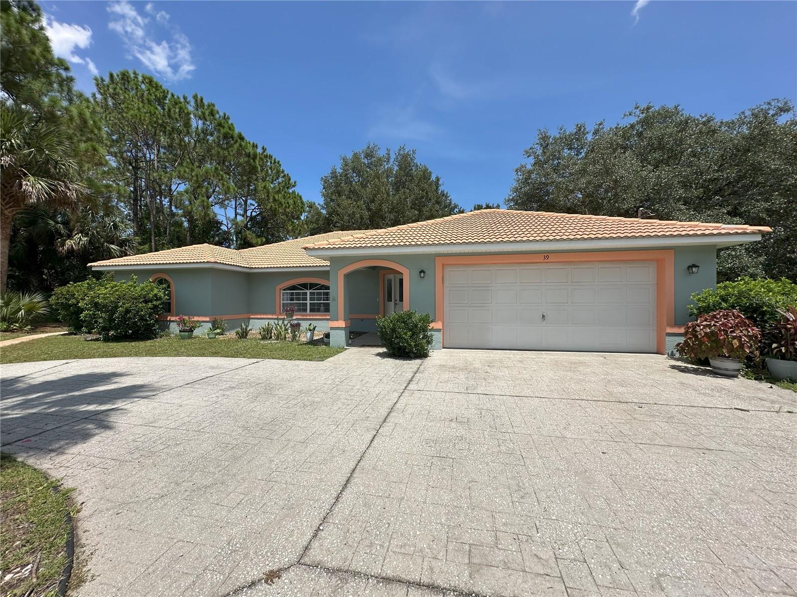 This is a spacious 3-Bedroom/2-Bath TILED ROOF HOME located on a quiet street in the highly-favored Belle Terre subdivision of Palm Coast. It's close to US 100, I-95, and US 1, and not far from some of the hottest retail properties in Flagler County, including Shopping, Dining and Entertainment, as well as Doctors, Hospitals, Recreation, Parks, and our beautiful Florida beaches! Set on an OVERSIZED 0.32-ACRE CORNER LOT on Princess Ruth Lane, this LIGHT-FILLED HOME pairs everyday comfort with Smart, Practical Upgrades. Fresh INTERIOR and EXTERIOR PAINT and NEW CARPET set a crisp, move-in-ready tone the moment you walk in. The main living areas open under VAULTED CEILINGS with PLANT SHELVES, BULLNOSE CORNERS (the rounded edges provide a softer curved profile), and ARCHED WINDOWS that add architectural interest and lots of natural light. At the back of the home, gathering spaces connect easily to a Large TILED and SCREENED LANAI--a true Indoor/Outdoor Living Area perfect for coffee at sunrise or evening dinners al fresco. The split Primary Suite features a TRAY CEILING, THREE CLOSETS--including a WALK-IN CLOSET and a LINEN CLOSET--and a Generously-Sized EN SUITE BATHROOM with an ARCHED WINDOW and WALK-IN SHOWER with TILED WALLS and TILED CEILING. SLIDING GLASS DOORS from the Suite and another from the FAMILY ROOM lead out to the LANAI and its soothing views of Dappled Sunlight streaming through the MATURE TREES and PLANTS, all part of the natural beauty of the LARGE BACKYARD. Everyday function shines with an Inside LAUNDRY ROOM with POCKET DOOR, and in the Garage you’ll appreciate the UTILITY SINK, NEWLY-EPOXIED FLOOR, and an ELECTRICAL PANEL set up for a WHOLE-HOUSE GENERATOR (generator not included). And let's not forget the CIRCULAR DRIVEWAY that provides additional parking and an easy in-and-out, as well as the CONCRETE WALKWAY that wraps around the North-Side of the House. There's an Irrigation Well and Sprinkler System present that's currently inoperable; they convey "As-Is." Recent/Mechanical notes (from Seller): The 2014 HVAC has a new motor with a warranty remaining, and the Water Heater was replaced in April 2021. With its large lot size, comfortable layout, and practical upgrades, this property is an excellent value and a terrific Palm Coast find.