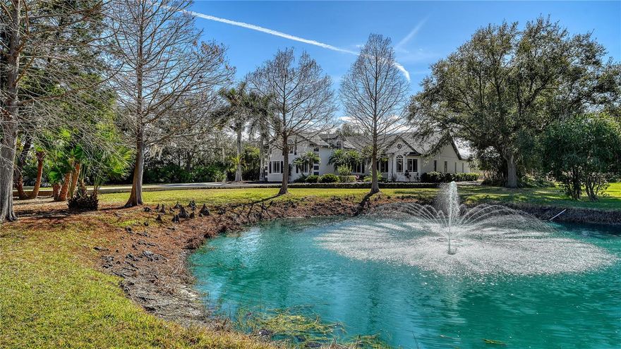 Set on nearly an acre in the private, deed-restricted community of Oak Ford, this updated residence offers a rare blend of space, privacy, and water views. Overlooking tranquil ponds, the property enjoys a peaceful, natural setting while remaining conveniently close to Sarasota’s many amenities.
Recent improvements include a new roof in 2023, PGT impact windows and doors, and newer appliances, further enhancing the home’s appeal and move-in readiness.
Offering more than 3,700 square feet of living space, the four-bedroom, three-bath layout is designed for both comfortable everyday living and effortless entertaining. Vaulted ceilings and an open floorplan enhance the sense of scale, while PGT impact windows and doors provide added protection and efficiency. An oversized foyer creates a welcoming first impression and leads into the main living areas, where unique polished concrete flooring, a central gathering space, and a well-appointed kitchen come together beautifully. The kitchen features custom solid-wood cabinetry, stone countertops, stainless steel appliances, and generous prep space.
The first-floor primary suite creates a private retreat with direct access to the outdoor living areas. Two additional bedrooms are located on the main level, while the second floor offers an expansive fourth bedroom or flexible bonus space ideal for a home office, gym, media room, or studio.
Outdoor living is a standout feature of this expansive property. The screen-enclosed, heated pool and spa overlook a south-facing backyard with pond and lush preserve views, offering a serene setting for relaxing or entertaining. A waterside fire-pit seating area adds another inviting destination and the perfect way to end the day. This nearly one-acre homesite also includes a three-car garage and an extended driveway, allowing ample room for parking and storage.
Oak Ford is known for its oversized parcels, custom-built homes, and peaceful setting, all within one of Sarasota’s most sought-after school districts. Just a short drive west, downtown Sarasota offers acclaimed dining, arts, and waterfront experiences, while St. Armands Circle and the Gulf beaches — including Siesta Key, Lido Key, and Longboat Key — provide some of the area’s most celebrated coastal attractions.