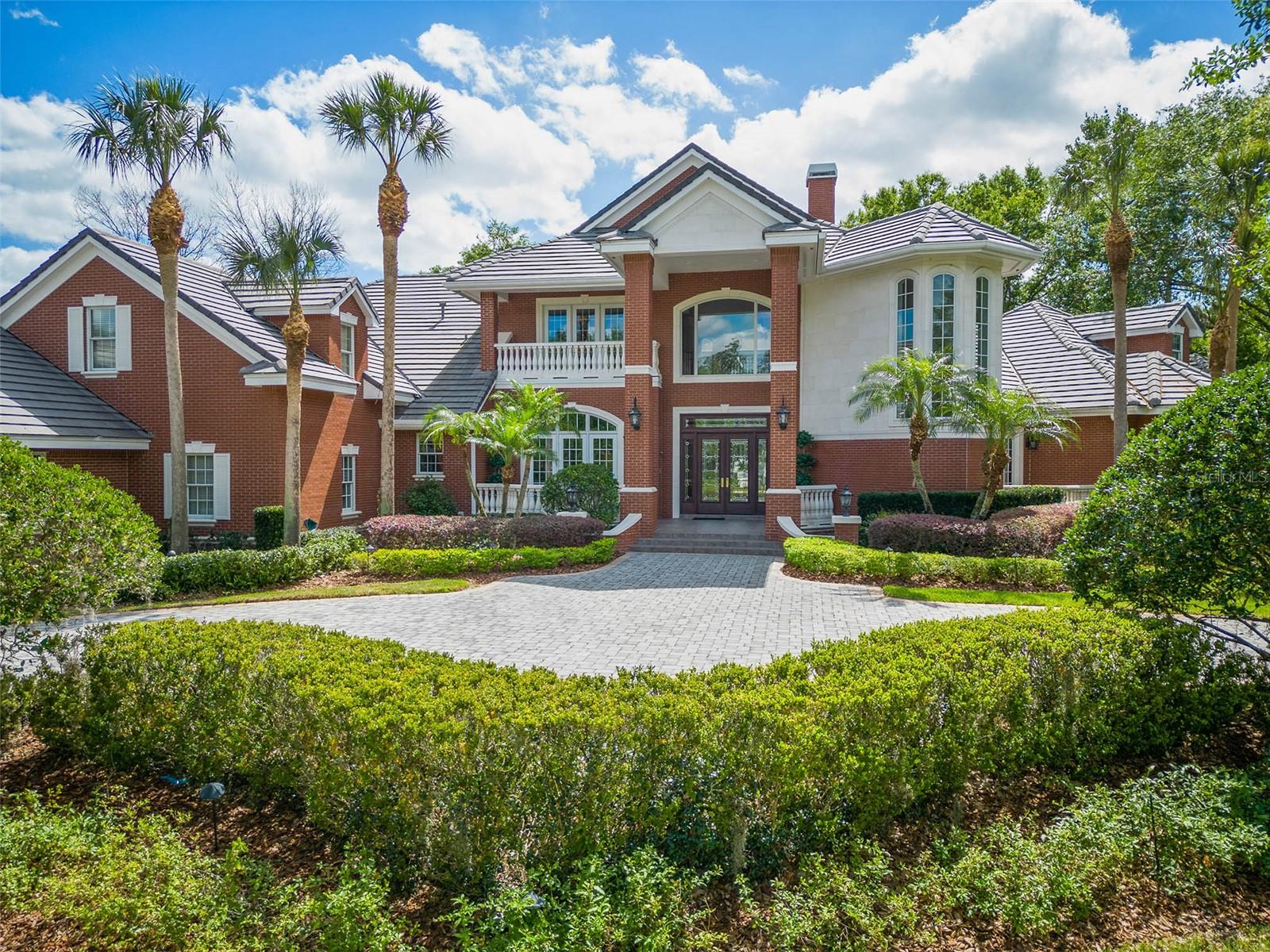 Exquisite estate home in Windermere’s private Sunset Bay community, adjacent to Lake Down and Isleworth. Custom built on nearly an acre of land, the owners of this home spared no expense when it came to designing and building. Highlights include 5 bedrooms, 6 full baths, 3 half baths, Waterford chandeliers, a home elevator, a private pool and spa with waterfall, a 5-car garage with a gated motor court, a Kohler home generator, and so much more. Offering an impressive 6,400+ sf floorplan, the interior layout includes formal living and dining rooms, two master bedrooms (each on the first floor) 3 en suite guest bedrooms, a chef’s kitchen with high-end Thermador appliances, an open family room, a 2nd floor bonus room, and two air-conditioned workshops. Throughout the home you’ll find beautiful hardwood floors, high coffered and tray ceilings, an abundance of natural light, thick crown moldings, custom built-in libraries and entertainment centers, stained glass windows, and two gas fireplaces. Enter the home through the grand 2-story foyer. Ahead you will find the living room, to the left the dining room, and to the right the home office. Down the first hall to the right are the master bedroom and the mini-master suite. At the heart of the home is the chef’s kitchen with Busby cabinetry, granite countertops and a large dinette area that overlooks the family room and screened pool and lanai. Split from the master wing you’ll find two guest bedrooms each with their own full bath, the laundry room, a full pool bath, as well as a half bath, and access to the attached 3-car garage (a second 2-car garage can be found across the motor court). Take the grand staircase upstairs where you’ll find another half bath and a large bonus room with a walkout terrace that overlooks the outdoor living space and a fifth en suite bedroom (which could be used as a home theater). Additional highlights and features include natural gas, 5 HVAC units, concrete tile roof (recently cleaned and inspected), central vacuum system,15-rifle safe, new water heater, new pool heater, two oversized 1,200 and 1,500 gallon septic tanks, and a Terminix termite bond. This home has so much to offer that there isn’t room to write about it all. Schedule your private showing today and see all the amazing features this home has to offer. Room Feature: Linen Closet In Bath (Primary Bedroom).