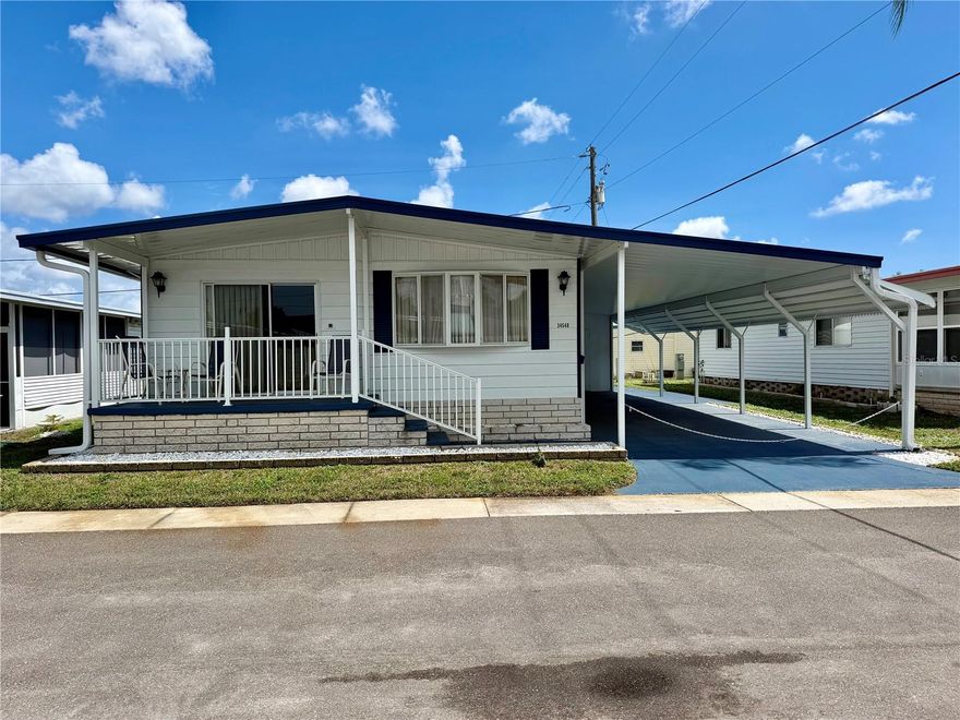 Sunset Palms was rated TOP 5 retirement communities for 2025! Well maintained home with lots of updates: New carport/front porch covering/Gutters/extended carport and painted driveway in 2025… HVAC 8/2024… thermal PANE WINDOWS… fresh exterior paint… recently installed vapor barrier… an aluminum ROOF-OVER in 2008/resealed 2025. Home features an inside laundry room, very spacious living area, bedrooms and bathrooms. This price includes the Share, valued at $55,000! Sunset Palms is Inexpensive living at only $210 per month which includes all the amenities one could want; owned clubhouse, escrows are fully funded, beautiful heated pool and spa, fitness center, library, shuffleboard, billiard table, and a small lake at the back of the park, laundry room, and your very own private entrance to the super Walmart… On foot, bicycle or golf cart… Etc., etc. Perfect location; for quick access to the beaches, Downtown St Pete, etc. Just hop on 275, which will get you to the Airports, Sarasota, Tampa, etc.