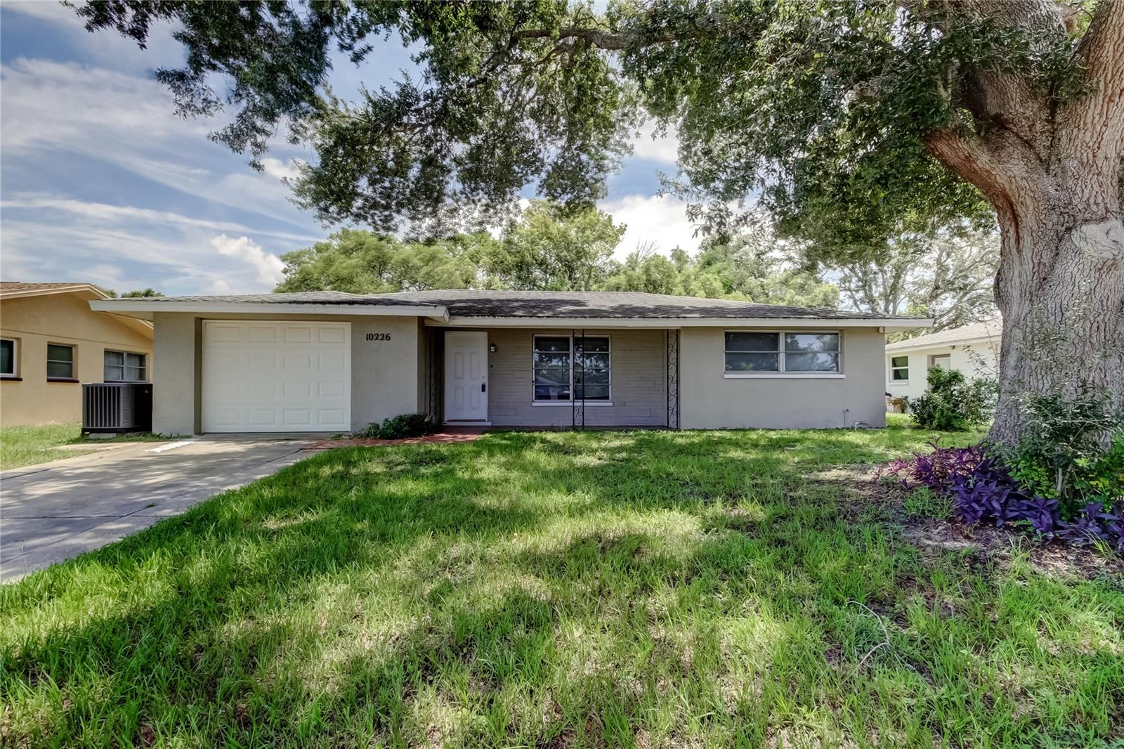 This beautiful 3BR 2BA home with modern updates offers an open concept layout designed for relaxation and entertainment, situated in the peaceful community of JASMINE LAKES. Step inside and find the perfect blend of comfort and style with attractive tile flooring and a spacious living and dining area. The renovated kitchen has granite countertops and the lighting and ceiling fixtures in the home have brushed nickel accents. Both baths have newer vanities and fresh updates, while the primary bedroom has an ensuite bath. The split bedroom layout offers the flexibility for using the 3RD Bedroom as additional living space, a playroom, home office, exercise room or whatever suits your lifestyle! The oversized 1 car garage with inside laundry is perfect for extra storage! The roof, AC and water heater were installed in 2018, there is no HOA or CDD and your new home is located in Flood Zone X. Step outside into a screened porch with decorative mosaic tile and into your quiet backyard! This charming property is located minutes to shopping, restaurants, recreation, schools and near the Werner-Boyce Salt Springs State Park where you can explore nature trails or kayak on the natural springs or enjoy a beach day at Robert R. Kees Memorial Park. Take a drive to vibrant downtown New Port Richey with its waterfront dining, music and retail therapy! This home’s fantastic location is ideal for first time buyers and snow birds or add it to your investment portfolio!