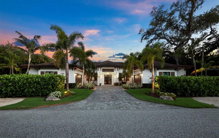 Welcome to this exquisite Heritage-built British West Indies style residence where elegance, quality craftsmanship and designer features merge in over 4,000 SF of one-level living.  Situated on an oversize West of Trail lot, it is an oasis of relaxation in the Oyster Bay area. Thoughtful details are found throughout, from dramatic light fixtures to vaulted wood ceilings and a fireplace with a stone surround. Entertain guests effortlessly with the gourmet kitchen complete with top-of-the-line Thermador appliances, a Wolf gas range/oven, solid wood custom cabinetry, quartz counters, and an immense marble center island with a breakfast bar plus separate dining room all within an open floor plan. Refreshments are made easy with a custom-built dry bar and wine fridge. Four en suite bedrooms, dual offices, and a spacious bonus/TV lounge room offer an abundance of versatile space for living, remote work, or creative endeavors. Embrace the Florida lifestyle with multiple sets of pocket sliders leading to the expansive outdoor living areas. Enjoy al fresco dining with the outdoor kitchen and travertine lanai, or lounge by the electric and gas-heated bromine pool and spa with a waterfall, all set against a backdrop of lush landscaping and lighting. You can have comfort and peace of mind in this home with HURRICANE RATED IMPACT DOORS AND WINDOWS and a WHOLE HOUSE GENERATOR plus dual on-demand hot water heaters. French doors lead to the private primary bedroom suite featuring a vaulted wood ceiling, dual walk-in closets, and a door to the covered lanai. Indulge in the sophisticated primary bath with a sumptuous soaking tub, spacious floor-to-ceiling tiled shower, and dual vanities. With an oversized lot, expansive paver driveway, gorgeous landscape and lighting, and a four-car garage (two cars in the west side/two cars in the east side), one equipped with an EV outlet and mini split AC, this home has it all and is within easy reach of downtown Sarasota, shopping, and restaurants. Located close to the historic Field Club (where you can join for social activities, tennis, dining, and boating), Siesta Key, and Southside Village. Come and discover Florida living at its finest.