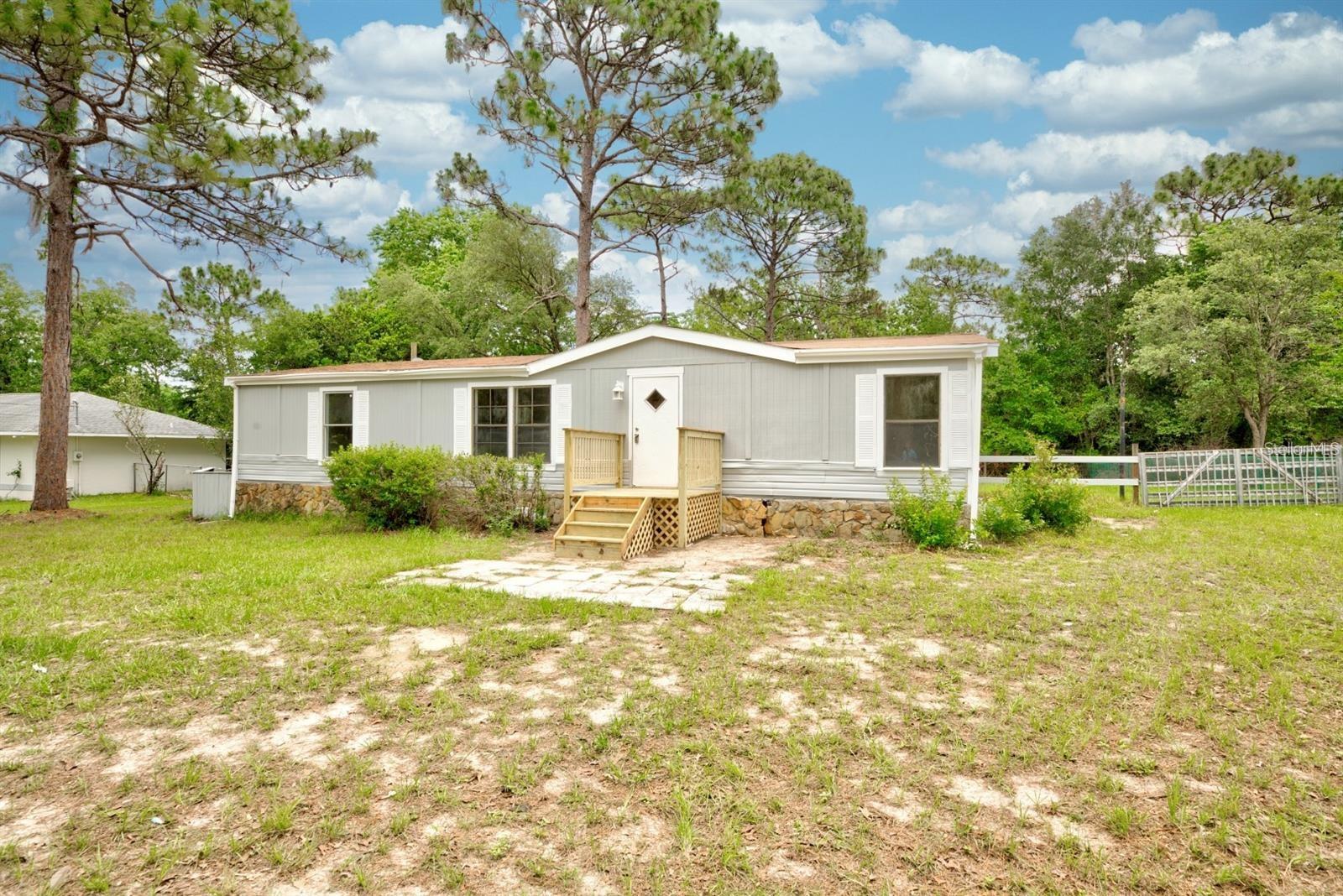 This charming 3-bedroom, 2-bathroom mobile home is nestled among trees in a peaceful natural setting. The home features an open-concept living room, dining area, and kitchen combo—perfect for family gatherings. It comes fully painted and includes stainless steel appliances for a modern touch. Conveniently located near schools and essential services, it offers the perfect balance of comfort, nature, and accessibility.In half acre of land, excellent whend you have RV and bots.