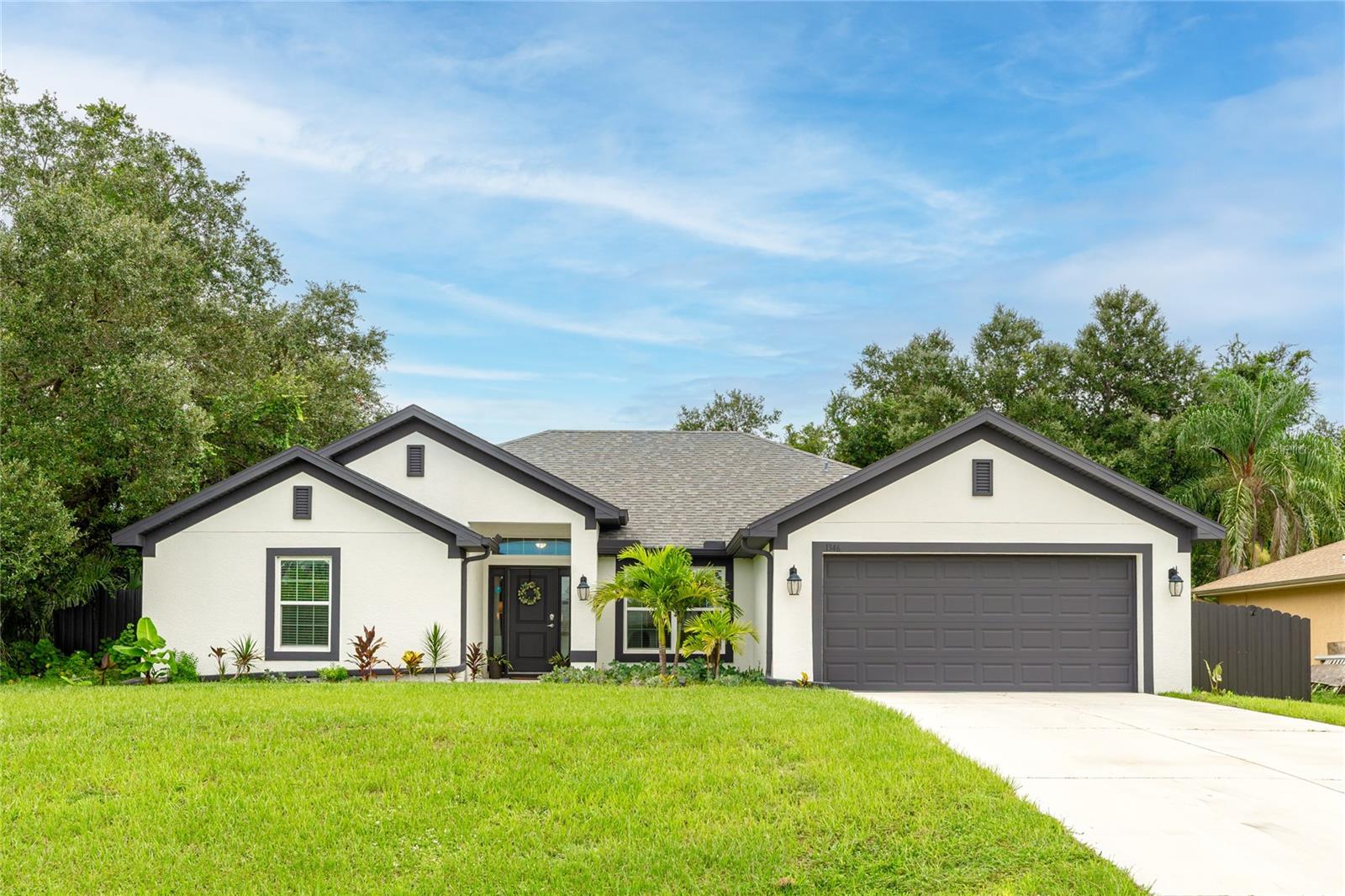 Discover a home that blends comfort, style, and the beauty of nature. With four bedrooms, three bathrooms, and over 2,100 square feet of living space, this residence is designed for both relaxation and entertaining.
The open floor plan and vaulted ceilings create a bright, airy atmosphere, while the chef’s kitchen steals the show with blue cabinetry, granite countertops, and stainless steel appliances. Whether you’re hosting friends or enjoying a quiet evening in, this space makes every moment feel special.
The spacious primary suite is a true retreat, featuring an en suite bath with a double vanity, large walk-in shower, and walk-in closet—perfect for comfort and convenience. A split-bedroom layout further enhances privacy, complemented by a Jack-and-Jill bathroom, interior laundry room, and ample closet space throughout.
Elegant wood-look tile floors bring sophistication to the main living areas, while plush carpet in the bedrooms adds warmth.
Step outside through French doors to your own slice of paradise. The 21' x 10' covered lanai overlooks a peaceful backyard framed by Florida’s natural beauty—a perfect setting for morning coffee, evening sunsets, or year-round outdoor living.
Here, every day feels like a getaway. Experience the best of Port Charlotte living and schedule your private tour today.
