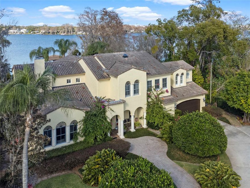 This STUNNING WINTER PARK LAKEFRONT ESTATE HOME IS A LUXURIOUS PRIVATE PARADISE.  Situated on an expansive lot, this home has over 100 Ft of LAKEFRONT on PRISTINE LAKE KILLARNEY.   Upon entering this GORGEOUS ESTATE you are welcomed into the GRAND foyer through the SOLID WOOD arched custom front door.  As you walk through this home you will see that it was built for Superb ENTERTAINMENT.  Your eye will be drawn to the floor to ceiling windows, SOARING ceilings, and OPEN FLOORPLAN overlooking the absolute GORGEOUS VIEWS of the sparkling POOL & LAKE!  The well appointed kitchen has CUSTOM designed 42in SOLID WOOD cabinets, granite counters, double oven, OVERSIZED refrigerator, and much more!  The breakfast area has an array of windows to let all that NATURAL LIGHT inside. Built for family gatherings, this home has a huge game room and screened in lanai.  Sit & relax on the covered patio and cool evenings, turn on the cozy fireplace.  The ROOF TOP TERRACE will be the place to take in all that Florida sunshine and breathe in fresh air off the lake. The luxurious MASTER SUITE includes a spa-like jetted soaking tub with a double sided fireplace. Dual sinks, separate shower, large walk-in closet, and a PRIVATE PATIO overlooking the lake. Upstairs you will find a LARGE OFFICE with built-ins and a fireplace. Take a break from work and enjoy the view off your private balcony.  Also there are three more bedrooms upstairs and a WORKOUT room.  Plenty of room to swim in the 40,000 gallon SPARKLING POOL and SAUNA.  The covered BOATHOUSE has a deck and a boat lift.  Additonal features include: storage/workshop in garage, electronic gated entry,  brick walkways, PRIVATE COURTYARD,  BBQ/wet bar,  PLANTATION SHUTTERS. Lake Killarney is a 239 acre  ski and FLY-IN lake.  Just a mile away from Park Avenue & Rollins College. Easy access to shopping, cafe's, Downtown Orlando and I-4. 
This is the perfect luxury estate for those who appreciate the beauty of nature combined with modern luxury.