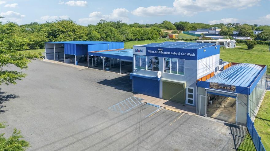 Located in Arecibo, this turn-key commercial property includes both the real estate and the operating business: Vista Azul Express Lube & Carwash. The fully equipped service center offers oil change and light mechanic bays, tire and alignment services, vehicle inspection and registration, and a complete car wash. It also features a reception area and a coffee shop with a fully outfitted kitchen. The second level provides additional leasable space, creating extra income opportunities.
The property spans approximately 4,530.45 m² of land, with a gross building area of 8,591.61 sq. ft., and includes three bathrooms, solar panels, a power generator, a tool shop, and all main equipment (inventory available upon request). Zoned R-I and outside of flood areas, its prime location on the main access road offers excellent visibility and heavy traffic. With its size, zoning, and existing infrastructure, this asset presents strong potential for multiple uses and future growth. CRIM: $489 annually