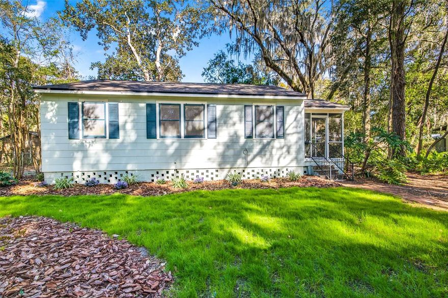 Beautiful Blanding bungalow includes a spacious bonus room on a quiet street just east of the historic Duckpond neighborhood. This move-in ready home features gorgeous heart pine wood floors and lots of natural light that cascades through the south-facing front windows. Heart pine wood floors in the living, dining and bedrooms. The large family room includes a wood burning fireplace and east-facing sliding glass doors that step down into a lovely side yard, shaded by a mature live oak tree. The lot also features a magnolia tree, palm tree, crepe myrtles, a hearty hedge and established philodendron. There is a dedicated laundry area in the addition just next to the side door that provides easy access to the detached garage. All trees were professionally trimmed in 2026. The screened porch is shaded and private. Recent updates include a new shed roof in 2026, main roof in 2017, HVAC in 2022, tankless hot water heater, and fresh paint in 2026. Special house that has been thoughtfully and well-maintained over the years.