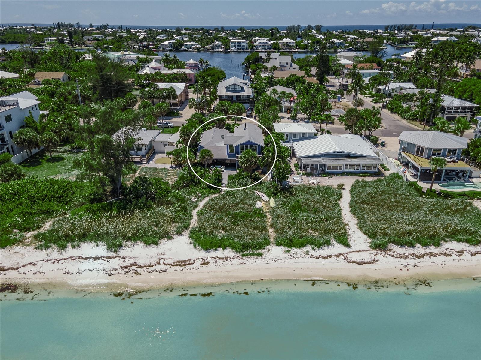 Hurricane Damage from Helene and Milton. True Island living at its best. Imagine raising your family on Anna Maria Island walking right out your door through sea oats and sand to play on the beach, swim in the calm Gulf waters or fish from your private beach. Family owned for the past 24 years and living their best life paddle boarding, kite surfing, yoga on the beach and so much more! I have not even mentioned yet the spectacular views of the Gulf, Anna Maria City Pier and the Sunshine Skyway bridge. This large waterfront parcel is 8,673 squ feet with a 4BR/4BA home. Open floor plan with volume ceilings. The large primary bedroom is located on the second level and has even more spectacular views. The 3 additional bedrooms are located on the ground level. Update the existing home or build new on this amazing lot.