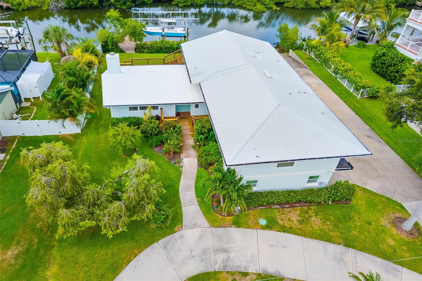 Welcome to Snead Island and discover the ultimate combination of privacy, luxury, and waterfront living in this beautifully updated 3-bedroom, 3.5-bath, 4 car garage home with your own private boat ramp. Tucked away in a serene setting, this property offers a rare level of seclusion while still providing direct access to the Manatee River making it perfect for boating, fishing, and enjoying Florida’s coastal lifestyle. From your backyard, launch directly into adventure with your private boat ramp and boat lift on a deep-water canal just minutes from open water. Whether it’s a sunrise fishing trip or a sunset cruise, your boating days couldn’t be easier. Step inside to a newly renovated kitchen, featuring upscale cabinets, huge quartz counters, and stainless appliances that make cooking and entertaining a delight. The open-concept layout flows effortlessly into the living and dining areas, all filled with natural light through hurricane-impact windows. Retreat to the private primary suite, complete with an en-suite bath and large closet. Two additional bedrooms provide flexibility for guests, family, or a home office. One bedroom having its own entrance making it a great option for an in-law suite. Outside, lush tropical landscaping frames your waterfront oasis. The secluded double level deck and large covered paver patio allows you to relax in complete privacy while watching the wildlife from your own backyard. This home also features a four car garage, ample parking space, and a circular driveway. Just minutes from Emerson Point Preserve, Bradenton Yacht Club, all your shopping needs and easy access to major highways and Florida beaches. Schedule your private showing today!