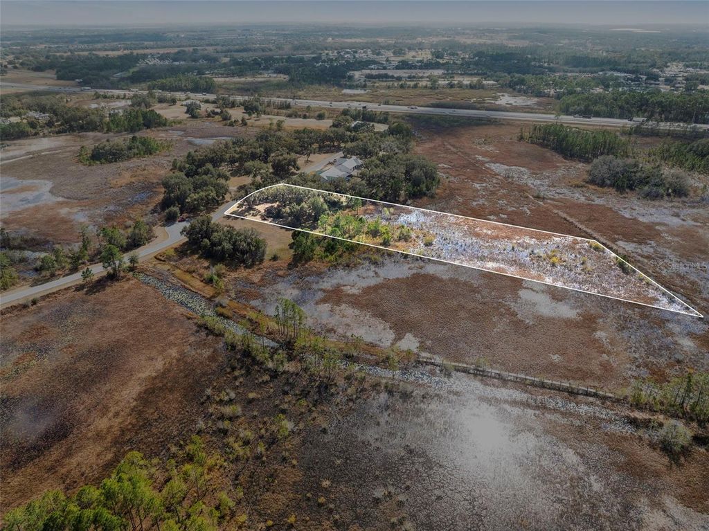 Photo of 446 Long And Winding Road, Howey In The Hills, FL 34737 (MLS # O6386207)