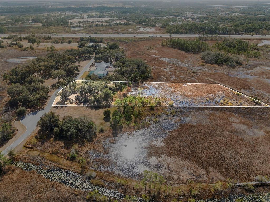 Photo of 446 Long And Winding Road, Howey In The Hills, FL 34737 (MLS # O6386207)