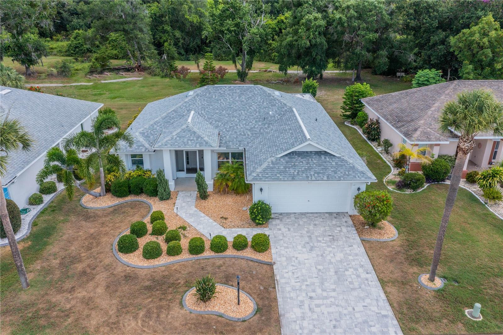 Curb appeal and updates galore are what stand out in this 2 Bed/2 Bath + Den Kingston model. New Roof - 2024, New HVAC - 2024, Hurricane Shutters throughout - 2016, Hot Water Tank - 2015, Updated electric panel and updated plumbing. Paver driver and updated curbing around all planting beds. Tile everywhere on the inside (NO CARPET). Updated kitchen with stainless steel appliances. No back yard neighbors - just a view of trees and wildlife. Low HOA fees (just enough to cover the lawn care). Oversized guest bedroom. Office/Den added onto back of house in 2019 extending your indoor space. Oversized lanai to enjoy the views. Throw in the two car garage and inside laundry room you know you can stop searching ! Now let's talk about all that the premier community of Sun City Center has to offer. The community has an indoor pool, outdoor pool and walking pool as well as a state of the art fitness center. Other amenities include a softball diamond, pickleball and tennis courts, lawn bowling, shuffle board, archery range, dog parks and plenty more. There are over 100 clubs and activities in this active adult 55+ community with something to satisfy everyone. They say you are only bored in SCC if you choose to be! Stop by and take a tour of your new home before someone else grabs it.
