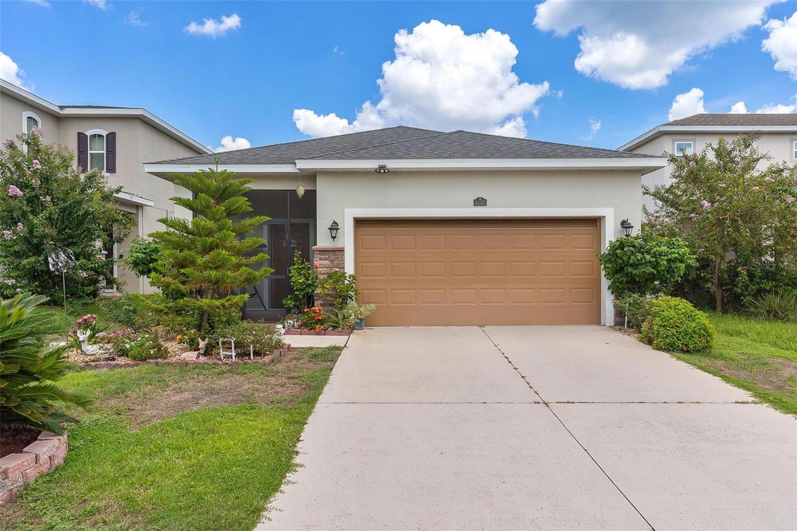 Welcome to Mirror Lake Village! This beautiful, like-new home is centrally located in the heart of Fruitland Park and offers an open floor plan with soaring ceilings. The kitchen features a spacious island with an eat-in bar, plenty of cabinet space, a closet pantry, and a sleek glass cooktop—all overlooking the living area with sliding doors leading to the backyard patio. The primary suite includes a large walk-in closet and an en suite bath with double vanities, a tiled walk-in shower, and a private water closet. Additional highlights include an inside laundry room, a versatile 12x9 tiled foyer that can double as a home office or study area, and a two-car garage with electric opener. Outside, you’ll find a nicely landscaped yard, perfect for enjoying Florida living.