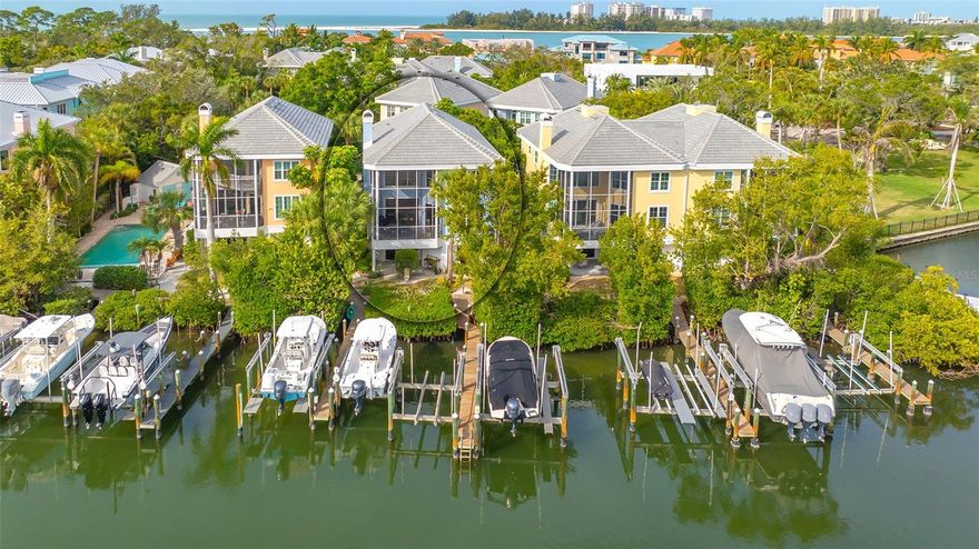 ABSOLUTELY FABULOUS SINGLE FAMILY HOME - MINUTES TO SIESTA VILLAGE AND BEACH! This 2,758 square foot, 3 bedroom, 3 ½ bath retreat is ideal for boating and beach-going. Located on Cocoanut Bayou, enjoy DIRECT ACCESS TO THE BAY, ICW AND GULF FROM YOUR DEEDED BOAT SLIP #6 with 7.5k lb lift, electric and water. Just two blocks to SHELL BEACH and minutes bike ride to SIESTA VILLAGE OR BEACH. Beautifully furnished with volume ceilings, abundant windows and sliding glass doors, this unit has a very spacious, light and bright feel. Luxury finishes abound including PRIVATE ELEVATOR, coastal wood flooring, crown molding, wood cabinetry, Thermador stainless appliances, and so much more. The large living room has custom built-in features including a gas fireplace, and opens to a screened lanai for grilling - overlooking the water. The gourmet kitchen with wood cabinets, 5 burner gas cooktop, built-in double oven and reclaimed cypress countertop adjoins the sitting room/breakfast nook - the ideal spot for relaxing and conversing before/after meals. The spacious dining area with wet bar and beverage refrigerator opens to the living room for gracious entertaining. Large master suite with abundant closets and bath, 2 guest suites and a spacious loft area for additional sleeping/den/office space make this an ideal family home or guest retreat. The first floor opens to a private patio overlooking the water and envelopes an oversized storage space and 3 CAR GARAGE.  New roof in October 2023!  Somerset Cove is a gated enclave of just 11 residences. This truly spectacular home is just one of two single family homes in the community directly on the water.  Enjoy awe-inspiring sunrises from your deck.  An unbeatable Siesta Key location, you will love the MAINTENANCE FREE lifestyle.  This is a must see! Room Feature: Linen Closet In Bath (Primary Bathroom).
