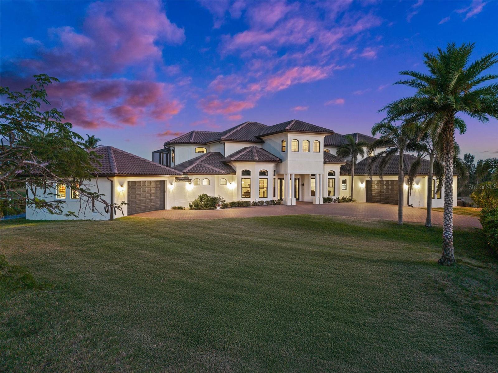 Live the Luxury Coastal lifestyle with this STUNNING SAILBOAT ACCESS 4 Bedroom, 4.5 Bathroom, 2 Car attached Garage & a 2 Car detached garage, TWO-STORY, Pool home with a Den, Family & Bonus rooms. Situated on a DOUBLE TIP Lot with 255ft of water frontage, a Wood dock & 16,000-lb boat lift, South Gulf Cove. Boasting over 5,200 square feet of living space, this home is bathed in natural light from expansive windows and offers BEAUTIFUL water views throughout, blending comfort, elegance, and scenic beauty. The living room impresses with soaring tray ceilings and breathtaking views, seamlessly connected to a formal dining room with a dry bar, ideal for entertaining. The GOURMET kitchen is outfitted with sleek, all-stainless steel appliances—including a built-in oven & convection oven/microwave— with granite countertops, a stylish tile backsplash, and a spacious center island. A wet bar with a wine cooler, a breakfast bar and ample cabinetry enhance the kitchen’s functionality. Just off the kitchen, a cozy dinette offers picturesque water views, while the family room provides a welcoming space for relaxation or gatherings. The main level includes a second master suite with French doors to the lanai, a walk-in closet and an en-suite bathroom with a dual-sink vanity, spa bath, and walk-in shower. A comfortable guest bedroom provides additional accommodations, while a flexible bonus room can be used as a second home office, media or music room, or extra bedroom to suit your needs. On the second floor, you will find a private and elevated living experience, beginning with a well-appointed guest bedroom featuring a built-in closet. A dedicated home office overlooks serene water views, creating an inspiring and peaceful workspace. The crown jewel of this level is the primary master suite, a true retreat with dual walk-in closets, a dedicated makeup vanity, and elegant French doors that open to a private balcony. The en-suite bathroom is designed for relaxation, showcasing a dual-sink vanity, a spa bath, a spacious walk-in shower, and a second set of French doors leading to a balcony with views of the pool below. Adjacent to the master suite balcony is the Florida room, a bright and inviting space designed for year-round enjoyment, featuring stunning water views and a mini-split A/C system for personalized climate control. Expansive windows flood the room with natural light, while a spiral staircase provides direct access to the lanai, seamlessly blending indoor and outdoor living. Step into your private outdoor oasis, with a large screened lanai designed for elevated coastal living. Entertain in style with an outdoor kitchen, complemented by a convenient half bathroom and an outdoor shower. Unwind in the heated saltwater pool and spa, w/ 2025 heater, all framed by serene canal views that offer beauty and tranquility. A true boater’s dream—this custom 8' x 255' dock is a waterfront showpiece, built for luxury waterfront living, equipped with water and electricity, this expansive dock includes a 16,000 lb. boat lift with a cover. 2024 TILE ROOF - IMPACT WINDOWS & DOORS - FURNITURE NEGOTIABLE - see feature sheet for more features! South Gulf Cove is a deed-restricted neighborhood with an optional HOA that offers members a clubhouse, waterfront park with playground, and private boat ramp. Conveniently located close to local shopping & boutiques, fine & casual dining, LIVE entertainment, and AWARD-WINNING BEACHES!! ADJACENT LOT AVAILABLE FOR PURCHASE