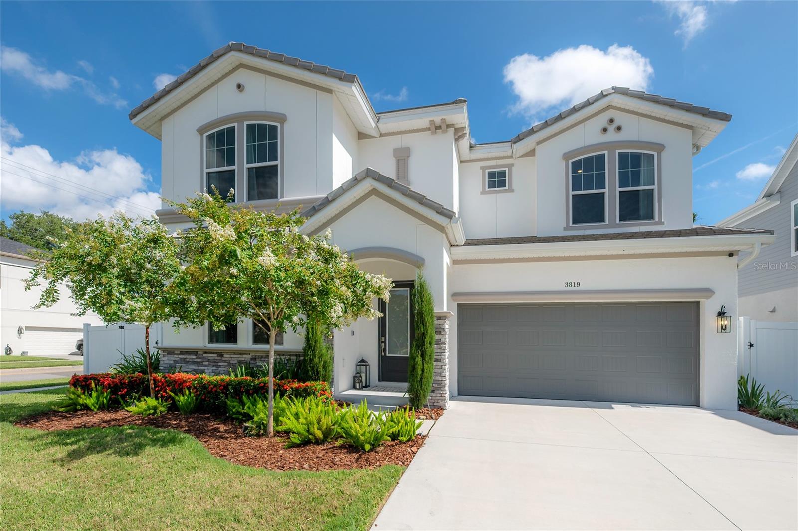 Impressive style and a prime location! This beautiful like new home, ideally situated on a corner lot in the heart of South Tampa features 5 bedrooms 4.5 bathrooms and a 3 car tandem garage perfect for your golf cart or additional storage. The thoughtful open concept floor plan flows from seamlessly indoors to the extended covered lanai with new pool and fenced backyard, complete with a convenient exterior pool bath—perfect for relaxing or entertaining. The kitchen is a true centerpiece, beautiful white cabinetry stacked to the ceiling, brushed bronze hardware, a massive ten-foot quartz island, a gas cooktop with a decorative wood range hood, and a built-in wine center. The adjacent dining area is ideal for family meals or dinner parties with friends. Designer details are found throughout the home. A private guest suite with full bath is also located downstairs. The dramatic staircase leads to a spacious upstairs bonus room—perfect for a playroom, movie nights or a second gathering space. Upstairs, the three way split plan offers privacy for all. The primary suite is filled with natural light and features a tray ceiling and detailed trim work. The en-suite bath offers a luxurious experience with a rain shower head, a freestanding soaking tub framed by full-wall tile, and a generous walk-in closet. The laundry room is also located upstairs for added convenience and includes a utility sink and folding table. Rev-wood covers the first and second floors and allows for a beautiful finish with the durability for pets or busy families.Located within the highly desirable Roosevelt Elementary, Coleman Middle, and Plant High School district, this property blends modern elegance and functional design in one of Tampa’s most sought-after neighborhoods and in Flood Zone X - NO required insurance.