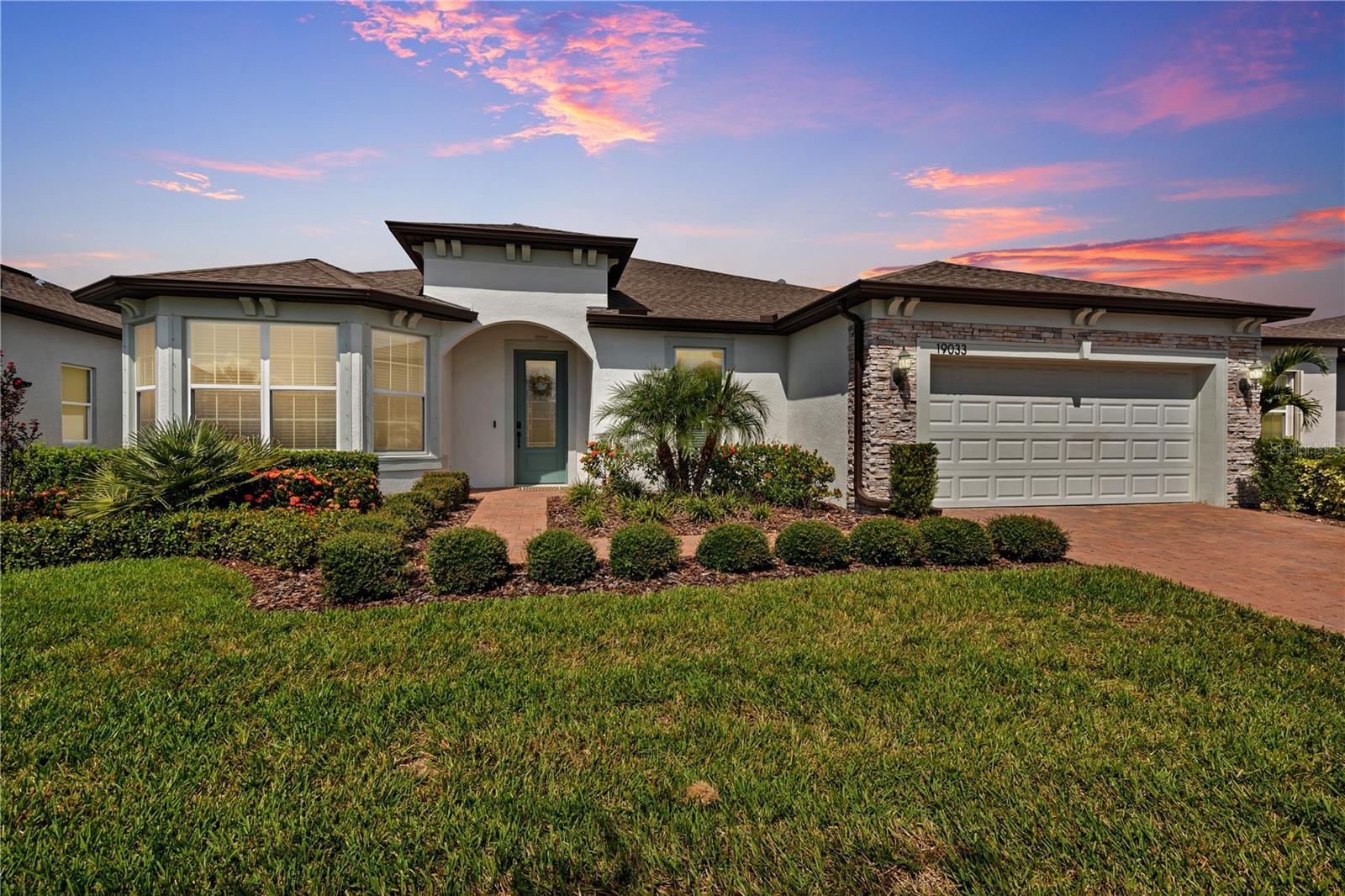 Enjoy the best of active adult living in this stunning Stardom model featuring 2 bedrooms + office or second living room, 2.5 baths, and a 2-car garage with abundant storage space, perfectly situated on a premium 65' wide Echelon lot in the gated 55+ community of Del Webb Bexley. Just a 2-minute stroll to the clubhouse, this move-in ready home blends luxury upgrades with unmatched convenience and looks like new.
Inside, you’ll find nearly every available upgrade: luxury vinyl plank flooring throughout, upgraded cabinets, quartz countertops, upgraded interior doors, premium designer lighting, crown molding in all living areas, and an upgraded walk-in shower. The open-concept gourmet kitchen boasts a large island with seating, walk-in pantry, stainless steel appliances, and stylish finishes. The kitchen flows seamlessly into the dining and living areas, all with tranquil pond views and sliding doors to the spacious screened lanai—perfect for entertaining or enjoying peaceful mornings.
A standout feature of this floor plan is the two oversized master suites. The primary suite is a true retreat, featuring a tray ceiling, pond views, and a luxurious en-suite bath with dual sinks, two custom-framed mirrors, quartz countertops, a spacious custom-tiled walk-in shower with a built-in bench, a linen closet, and a large walk-in closet. The second master suite also includes a full private bath and walk-in closet, providing comfort and flexibility for guests or multi-generational living.
Additional highlights include a versatile office/flex room with French doors and a thoughtfully designed garage entryway with built-in shelves, bench seating, and storage cubbies—the perfect drop zone for everyday convenience. The oversized garage itself provides ample space for a golf cart, hobbies, or seasonal items.
Del Webb Bexley offers a vibrant, active lifestyle with a 19,000 sq. ft. clubhouse, heated resort-style pool, resistance pool & spa, tennis, pickleball & bocce courts, state-of-the-art fitness center, on-site bistro, dog park, outdoor amphitheater, and year-round clubs and events. HOA-maintained lawn and landscaping allow you to spend more time enjoying the Florida lifestyle.
Move-in ready and looking like new showing this home offers nearly every upgrade, and an unbeatable location just steps from the clubhouse, this Stardom model on the large lot delivers the best of comfort, luxury, and active living.