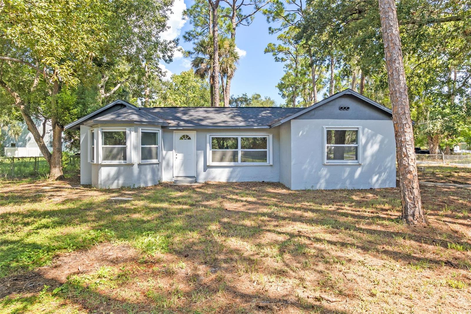 Welcome to this beautifully updated 3-bedroom, 2-bath home with 1,403 square feet of comfortable living space on an oversized corner lot, where thoughtful upgrades and modern touches create a move-in-ready retreat. A charming custom fireplace anchors the living room, while the kitchen shines with new appliances and a stylish backsplash. The master suite provides a serene escape, featuring a fully updated bathroom and a custom closet system for optimal organization. Throughout the home, you’ll find fresh light fixtures and new blinds that add warmth to every room. A convenient laundry room comes complete with a washer and dryer, and a brand-new shed provides extra storage or workspace. For peace of mind, hurricane shutters are in place to protect your investment. From its inviting interior to the carefully planned updates inside and out, this property is ideally suited for comfortable Florida living.