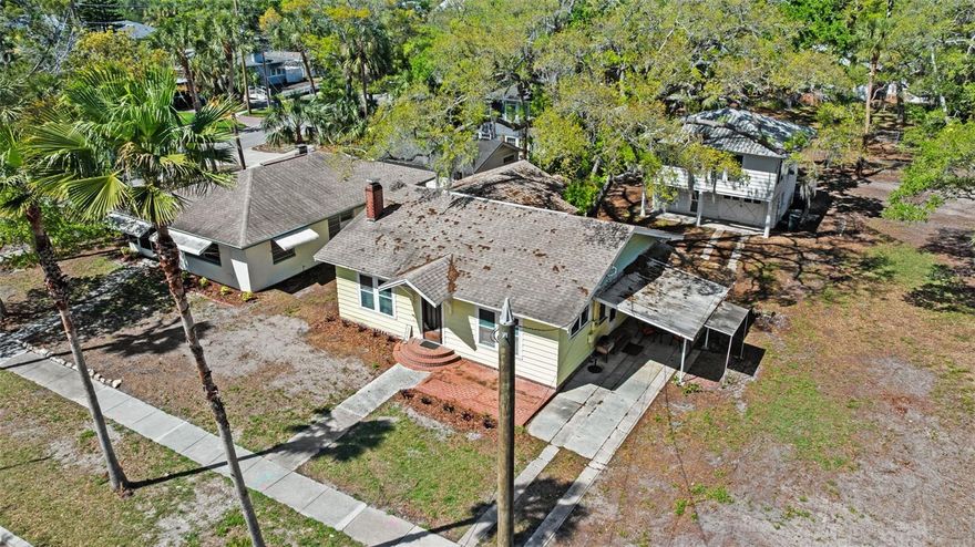 One or more photo(s) has been virtually staged. Iconic Downtown Opportunity | Live, Invest, or Create Your Dunedin Compound
Positioned at the corner of President St and Broadway St., this exceptional 0.53-acre property offers a rare opportunity in the heart of Dunedin. Just steps from the Pinellas Trail, two blocks to the marina, and a short stroll to Main Street’s renowned dining, shops, and waterfront, this location delivers the ultimate blend of charm, walkability, and lifestyle.
Zoned MF-7.5 with potential for up to four residential units, the property presents a unique canvas for a luxury compound, boutique development, or thoughtfully designed multi-residence retreat. Whether envisioned as a private family estate with guest homes, a seasonal coastal getaway, or a long-term hold with income, the flexibility here is what makes it special.
Three points of access (President St, Broadway, and rear alley) provide a level of optionality rarely found in downtown parcels—ideal for both future development and functional day-to-day living.
The grounds are anchored by majestic century-old Live Oaks, creating a timeless Old Florida setting that enhances both privacy and character. Existing improvements include three income-producing structures: a charming 2BR/2BA bungalow, a well-maintained 2BR/1.5BA ranch with terrazzo floors, and a 1BR/1BA garage apartment—offering immediate cash flow, multigenerational living, or the ability to live on-site while designing your vision.
Located in a sought-after golf cart district near TD Ballpark and the Dunedin Marina, this is a premier offering for those seeking a signature property in one of Tampa Bay’s most desirable coastal communities. The location is A+++ and demand for well-executed new construction in downtown Dunedin continues to grow. 
No short-term rentals permitted in this neighborhood. Buyer to verify all zoning, use, and development details.