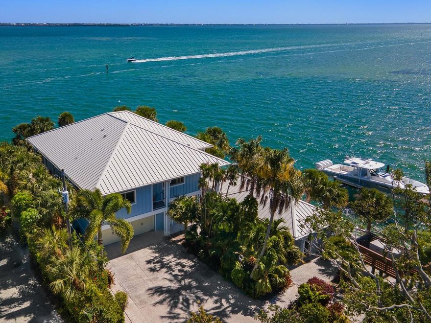 When superior strength meets breathtaking beauty, you have something very special. Welcome to 876 Tarawitt Drive on Longboat Key. This exclusive Bayfront home with separate cottage is a coastal masterwork built to fortress-like standards, offering unparalleled durability, safety and peace of mind in today’s environment. Engineered with all poured concrete, including the re-bar reinforced foundation, the property is also equipped with all Miami-Dade rated hurricane glass, a whole house generator and a corrosion-proof metal roof. These powerful features all contribute to a home that is exceptionally energy efficient, sound-proof and consciously in balance with the natural world. The interior design is nothing short of impeccable, with tongue-in-groove wood ceilings, coastal materials and seaside hues that flow effortlessly from space to space. Brazilian Teak, known for being one of the most durable woods on the planet, is the material of choice for the splendid outdoor decks overlooking miles and miles of glistening Bay waters. Significant investments in custom features, appliances and materials were made in both the main home and the cottage, with absolutely no detail overlooked. In short, this is a legacy home built to weather any storm, and to last for generations to come. Stretching gracefully for about 11 miles on the West Coast of Florida, Longboat Key is a coveted destination for those seeking serenity while still being close to amazing retail, culinary and healthcare amenities. It is the perfect setting for this once-in-a-lifetime property, built with purpose and power, and just waiting for you to discover.