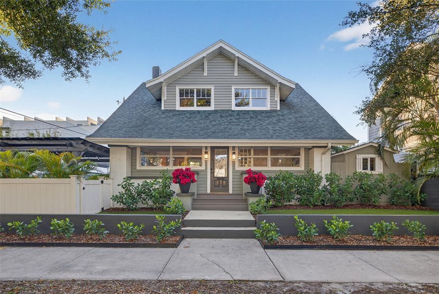 More than a home, this is a downtown lifestyle that most only dream of. Mornings begin peacefully here—no helicopters, no sirens, just the soft sound of birds greeting the day. From your front door, take a leisurely stroll to Perry’s on the Pier for a fresh coffee and enjoy the tranquil Vinoy Basin—all without the stress of parking, ever. Inside, rich hardwood flooring, dramatic coffered ceilings, and a stunning gas-burning fireplace anchor the main living space with warmth and sophistication. The chef’s kitchen is designed to impress, featuring premium Samsung appliances, soft-close shaker cabinetry, waterfall countertops, and a dedicated wine bar and coffee station that make both weekday mornings and weekend entertaining effortless. Upstairs, the primary suite serves as a serene owner’s retreat, offering peaceful skyline views and a calming escape above the city. An oversized guest bedroom, beautifully appointed guest bath, charming reading nook, and walk-in closet complete the upper level with thoughtful versatility. Every bathroom has been meticulously redesigned with designer vanities, custom mirrors, curated tilework, upscale fixtures, and Cosvalve washlets—bringing a refined, spa-like experience into everyday living. As evening approaches, embrace one of downtown’s simplest luxuries: walkability. Head just two blocks to the water at Vinoy Park to watch dolphins play against a breathtaking backdrop of pastel skies. Then wander to Juno & The Peacock—or any of the city’s acclaimed restaurants—again, with zero parking worries. It’s the freedom of condo living without the limitations or costs of an HOA. Additional highlights include 8.5-inch baseboards, select impact-rated windows, new designer lighting with recessed LED illumination, energy-efficient mini-split systems, natural gas appliances, and beautifully turfed low-maintenance outdoor spaces. A true downtown house—rare, refined, and irreplaceable—534 1st Street North offers the walk-everywhere, park-nowhere lifestyle so many desire but few ever attain. Live one block from the Vinoy, steps from everything, yet worlds above the rest. Schedule your private showing today and experience downtown St. Pete living at its finest.