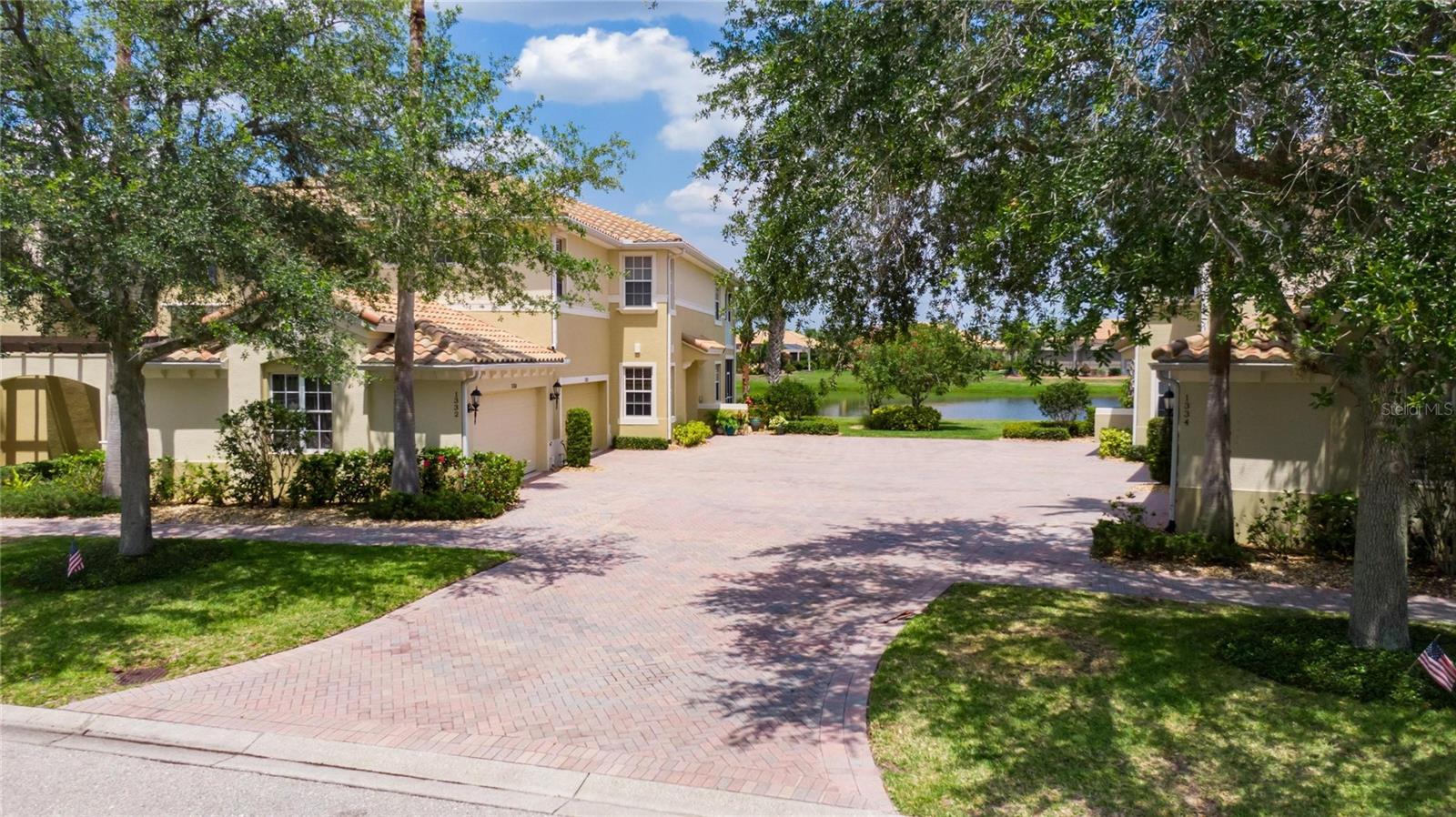 *WATCH VIRTUAL 3D TOUR ABOVE* FULLY UPDATED, MAINTENANCE FREE, LUXURY, WATER FRONT, BEST VALUE, first floor Condo cradled in the heart of the Renaissance community. MOVE-IN ready, COASTAL NEUTRAL TONES, FRESH PAINT, SPARKLING CLEAN & STUNNING WATER VIEW w/OPEN FLOOR PLAN. Condo has 10’ TALL CEILINGS with trey inserts, TALL ARCHED doorways, electrical wiring integrated into the walls, LARGE TILE laid on DIAGONAL & CROWN MOLDING. Walk into this handsome condo & immediately have a vista of sparkling water ponds & wildlife just outside your lanai. Kitchen boasts of lovely GRANITE Countertops, 2019 HIGH-END APPLIANCES (Gas Range), Honey color 42” tall ALL WOOD CABINETS soft close w/pull out drawers & WALK IN PANTRY with custom SHELVING. Dining area is perfect for intimate gatherings & private dinners. Living area is a VISTA of water views with sea breezes wafting through the condo. OWNERS SUITE is SPACIOUS with full WATER VIEWS, an EN-SUITE bathroom for ultimate privacy. ENGINEERED HARDWOOD makes this space the ultimate room for relaxing. A WALK-IN CLOSET with CALIFORNIA STYLE shelving has space for everything & is every owner’s dream. Due to the SPLIT PLAN, the remaining two bedrooms are on the other side of the condo for ultimate privacy, along with their own private bathroom. They are spacious, have LARGE WINDOWS for natural light & are ready for guests. The laundry room is generous with shelving, a utility sink and bright lights. Both bathrooms ARE FULLY UPDATED w/HIGH VANITIES, TALL TOILETS & SOFT CLOSE DRAWERS. The garage boasts of a beautiful patterned FLOOR, CUSTOM STORAGE SHELVES & is PLUMBED for a whole house water softener system. Condo has been meticulously cared for & loved; nothing has been overlooked for MAXIMUM ENJOYMENT. From the EAT-IN kitchen, living room & dining room, you can enjoy the water view and wildlife. The back screened patio is BRICK PAVED & even protected with ELECTRIC SOLAR SUN SHADES. The surrounding landscaping has been upgraded with CUSTOM LIGHTING in the plants & trees! You are literally 1 minute (walking) from the Renaissance Clubhouse (with a HUGE HEATED POOL and state of the art FITNESS CENTER) where you can meet up with friends and enjoy a drink or dinner. This is Florida living AT ITS BEST with such high quality of design and function. The building is a LUXURY four-plex with two condos up and two condos down – the upstairs condos have their own private entrances & there is 18” of dead air space between the floors to ensure silence/privacy. You are required to be a SOCIAL member of the Renaissance Country Club, which offers fitness center, pool, spa, restaurant and many more amenities. Sun City Center is a 55 and better community offering a state of the art fitness center, an indoor Olympic lap pool, an indoor resistance pool, outdoor pools, softball, pickleball, tennis, arts/crafts, woodworking, lawn bowling, dancing – all told 200+ clubs & activities. Many of us keep just one car and a golf cart, as everything here is accessible by golf cart. We are conveniently located near shopping, dining, and numerous medical facilities with easy access to Tampa, Sarasota, St. Petersburg, beaches, theaters & more. There is just too much to mention, which makes this a real value for the money. NOTE: All measurements are considered accurate, but must be verified by buyer. Roof, Entire Exterior & Landscaping all maintained by the Condo Association. A/C (w/Blue Light Air Purifying System) 2019; Water Heater 2019.