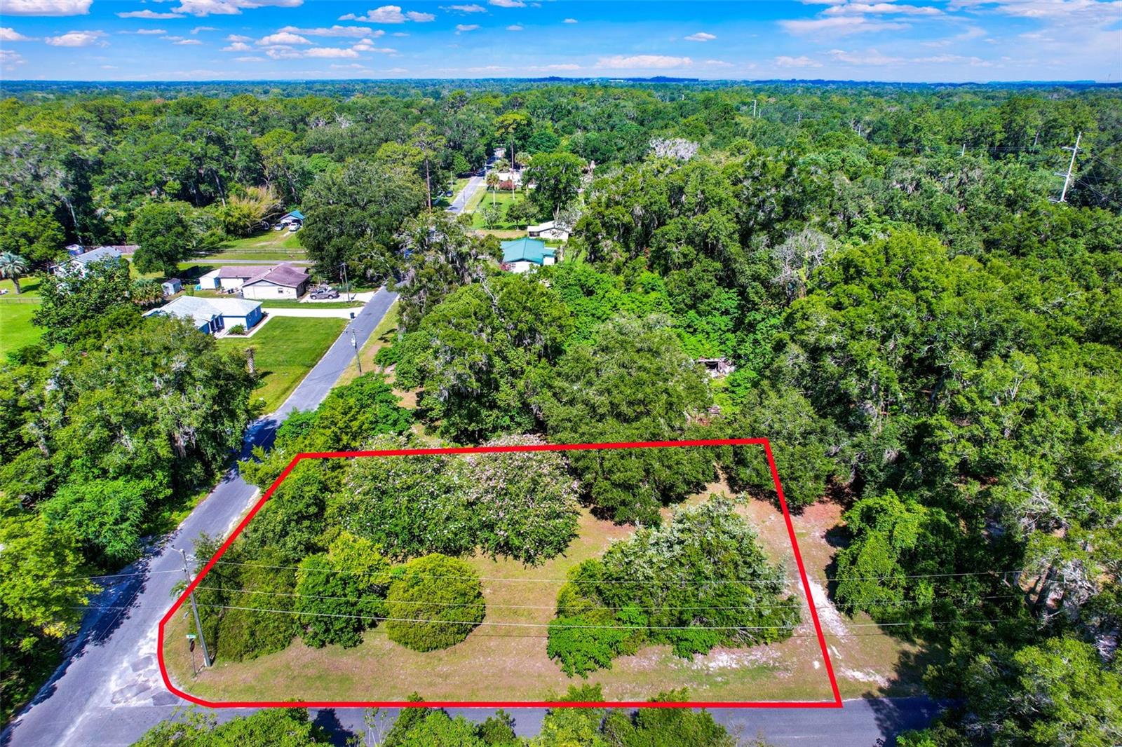 Welcome to 847 NE 31st Street, an investor special located on a beautifully maintained corner lot in the heart of Ocala, Florida. This property features an existing single-family home which you can remodel or tear-down and build your dream home from the ground up, offering a rare opportunity to avoid costly impact fees. The spacious parcel is adorned with mature flowering trees, lush greenery, and natural privacy, making it an ideal canvas for redevelopment or a fresh start in a rapidly growing area. The lot is level, cleared, and offers easy access to utilities, with paved roads and a quiet neighborhood setting that combines tranquility with convenience. Whether you're looking to create a custom residence or hold the land as a long-term investment, this property provides unlimited potential with no HOA restrictions to hinder your vision. Situated just minutes from Ocala’s vibrant downtown district, you’ll enjoy close proximity to a variety of top-rated restaurants, shopping destinations, and cultural venues including the Reilly Arts Center, Ocala Civic Theatre, and the historic Downtown Square. Outdoor lovers will appreciate being a short drive from Silver Springs State Park, known for its kayaking, glass-bottom boat tours, and scenic nature trails. Nearby medical facilities such as AdventHealth Ocala and HCA Florida Ocala Hospital ensure peace of mind, while access to major roadways like US-301 and I-75 makes commuting a breeze. Whether you're a seasoned investor or a future homeowner looking for the perfect spot to bring your vision to life, 847 NE 31st Street is a hidden gem with exceptional potential in one of Central Florida’s most desirable locations.