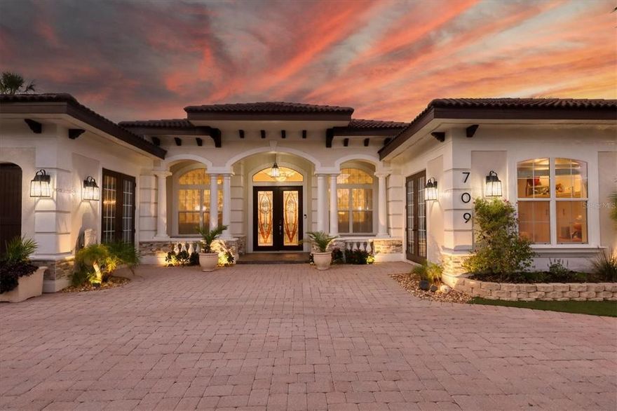 Sun, fun and a relaxed island lifestyle await in this incredible Siesta Key waterfront home. Sited on a large canal front lot just minutes from Siesta Key Village and the famous white powdery sand beaches, this home exudes the Siesta Key Island vibe. Boat, kayak, Jet Ski or paddleboard from the boat dock or relax at the end of the day by the amazing pool and large backyard, boasting calming long water views. Casual, comfortable and built for entertaining, this home features an open floor plan with high ceilings, polished travertine floors, neutral finishes and large banks of windows and doors to let the outside in and create the quintessential indoor/outdoor Florida lifestyle. There are sliding doors to the patio from the great room, kitchen, game room, owner’s suite and one of the guest bedrooms. The great room boasts a coffered ceiling, fireplace, built-in cabinetry and sliding glass doors that open to the patio. The adjacent kitchen and casual dining area include a captivating 450-gallon aquarium, wood cabinetry, stainless steel appliances and a long pass-through window to the outdoor bar. The game room/flex space is on the other side of the dining room and offers plenty of room for a pool table or even another living area. The owner’s suite is an oasis and features a frameless glass-enclosed shower, long vanity, a make-up desk, two water closets and a large closet with a dressing area. There are two guest bedrooms that share a bath and an additional en-suite bedroom. The patio, pool area, outdoor kitchen and backyard provide multiple options for spending the day into the evening, relaxing and entertaining friends and family. The entire yard is custom-installed artificial grass accented by palm trees, colorful plants, and landscape lighting. A functional laundry room with an extra refrigerator, a three-car garage and a paved circular driveway complete this amazing home.