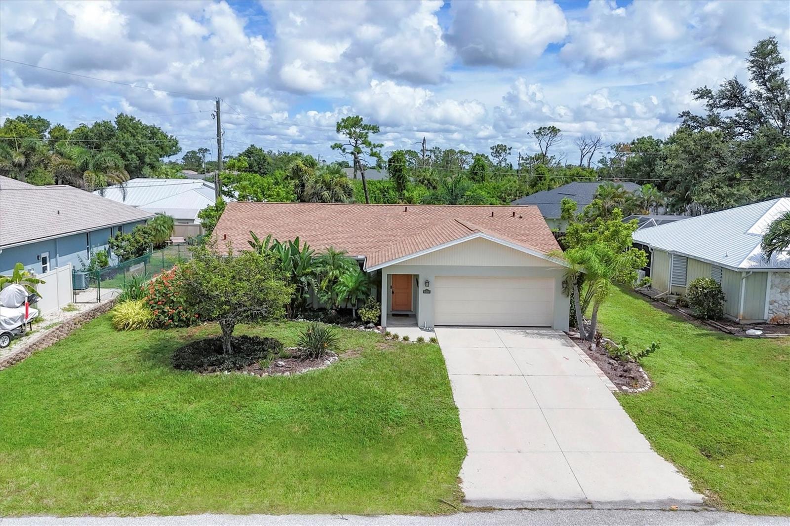This beautifully maintained, turnkey-furnished house features lovely, low-maintenance landscaping enhancing the newer entry door. The main living area boasts plank tile flooring, 5 ½” baseboards, a cathedral ceiling, and updated lighting. The remodeled kitchen includes updated cabinetry, granite countertops, stainless steel appliances, and a breakfast nook with sliding doors to the lanai. The master bedroom is spacious with newer carpet, two walk-in closets, and an updated master bath with stylish fixtures. The guest bedroom is inviting with a soothing color palette and the guest bath is equally updated. The two-car garage has a newer ceiling, automatic door opener (2022), and houses a washer, dryer, and sink. Recent updates include a newer roof (2023), high-efficiency AC (2015), additional insulation, and a large screened lanai with a custom wood ceiling. The saltwater pool was resurfaced (2015), with a new pool cage (2023), heater (2017), New pool pump and chlorine generator (2024) and Automatic pool filler (2024). Additional features include a newer septic tank (2017), a shed, and hurricane shutters/screens.This house has a robust rental history.