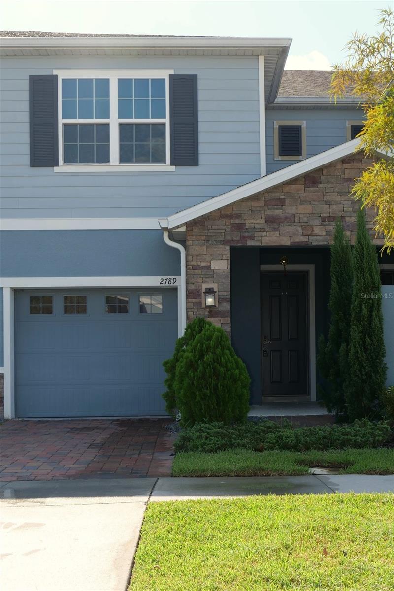 Stunning 3 bedroom 2.5 bath townhome located in the highly desirable, gated community of Cypress Ridge in Kissimmee! This spacious and beautifully maintained home offers the perfect blend of comfort, style, and convenience just minutes from The Loop, dining, shopping, theme parks, and major highways. Upon entry, you're greeted by a stylish open-concept living and dining area featuring expansive neutral tile flooring, contemporary lighting, and a modern ceiling fan. Natural light fills the room through oversized windows and sliding glass doors, creating a warm and refined atmosphere. Perfect for both relaxing and entertainment. The kitchen offers a clean, modern design with granite countertops, stainless steel appliances, and soft gray cabinetry. A spacious center island with pendant lighting provides additional prep space and seating, making it ideal for everyday use or entertaining. Upstairs, all bedrooms feature matching wood-look flooring throughout. No carpet. The generously sized master bedroom includes a large window, a ceiling fan, and ample space for a king-sized setup. The master bathroom offers dual vanities, a spacious walk-in shower with built-in bench seating, and a private toilet area for added comfort. Includes one car garage with private driveway and access to community pool.