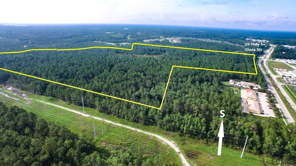 Under contract-accepting backup offers. 115+ acres, adjacent to new 690-acres golf course community with 274 home sites and underground utilities which is over 60% complete! This parcel has approved PUD agreement in place for up to 210 single family dwelling units and common improvements. In addition, commercial improvements can include 102,000+ SF of commercial and 36,000+ SF office development. Bordering on towns of Palm Coast and Bunnell and fronting on US Hwy 1, this fast growing residential community is ready for build out. Sale includes small adjacent parcel (0.519 acres), parcel ID #02-12-30-0000-00352-0047.