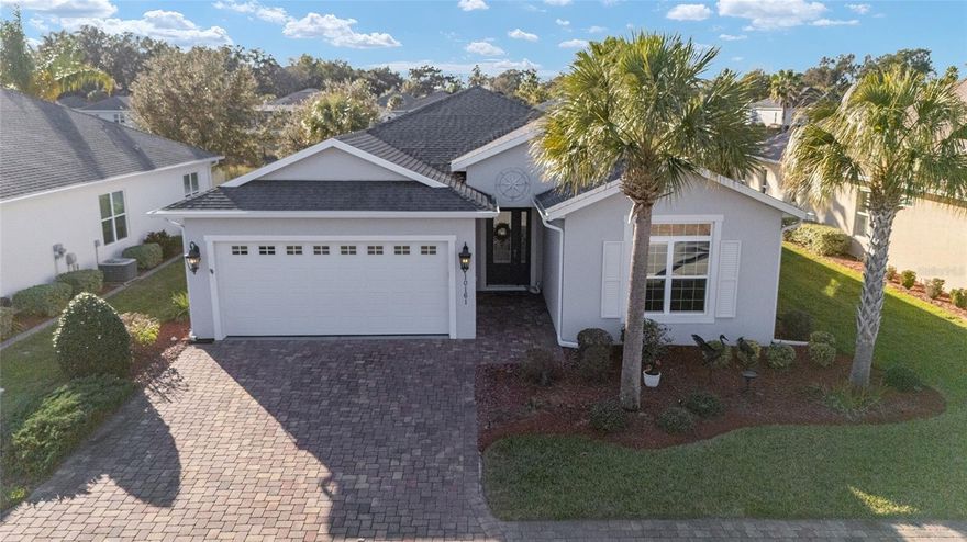 Gorgeous TURNKEY water-view home in the highly sought-after gated community of Lakeside Landings. This spacious open floor plan offers plenty of room for entertaining and hosting guests.  One of the best locations in the area — just a 12-minute golf cart ride to Sumter Landing, 15+ minutes to Spanish Springs, and less than 10 minutes to everyday conveniences including grocery stores, medical and dental offices, Home Depot, Lowe’s, Costco, the future Target, and more.  The home welcomes you with mature landscaping, a maintenance-free lawn, STUCCO exterior, and a PAVER driveway and walkway. A large entryway with coat closet leads into an OPEN-CONCEPT layout featuring 12-foot ceilings in the main living areas and CERAMIC TILE flooring throughout, with carpeted bedrooms for comfort.
The bright EAT-IN kitchen features Quartz countertops, STAINLESS STEEL appliances, and a large breakfast bar, making it ideal for casual meals and entertaining. The primary suite includes a 12-foot tray ceiling, TWO WALK-IN closets, and an en-suite bath with dual sinks on a Quartz-topped vanity, a linen closet, and a tiled ROMAN shower. A split-bedroom design offers three generously sized guest rooms, a shared bath, and an additional linen closet — perfect for guests or family.
Relax and enjoy stunning sunset views from the screened lanai overlooking the pond. The backyard offers room for a pool. The 2-car garage provides space for both your car and golf cart, along with additional overhead storage. Inside, the large laundry room includes a utility sink, LARGE-CAPACITY washer and dryer, and extra cabinetry. The home is also pre-wired for a security system.
The HOA covers exterior pest control, lawn care, and irrigation (including free lawn watering), making this truly maintenance-free living. Lakeside Landings is a fully gated community with impressive wrought-iron gates and resort-style amenities, including two pools, two in-ground Jacuzzis, a clubhouse with library and billiard room, FULL FITNESS CENTER, card room, putting greens, playground, basketball, tennis, and pickleball courts — all exclusively for residents. Kayak and enjoy the sunshine with access to Lake Miona.  NO BOND!