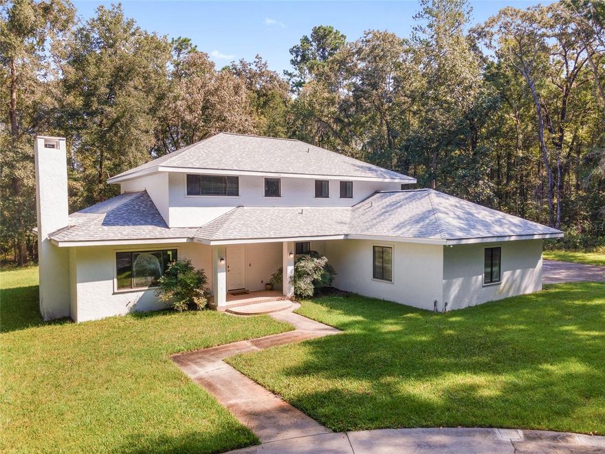 Opportunity Awaits in Millhopper Road Estates! Set on 5.31 peaceful, wooded acres, this spacious 4-bedroom, 2.5-bath home offers 2,873 square feet of potential in a private setting. Tucked back from the road with a circular driveway, this property provides a unique opportunity to create your dream home with room to grow, inside and out. Step inside to a generous foyer leading into a formal living room with wood-burning fireplace. A separate study makes an ideal office or reading retreat. The formal dining room features large windows with views of the natural landscape. The kitchen, remodeled in 2021, opens to a comfortable family room, offering a functional layout. A reverse osmosis system provides filtered water at the kitchen sink. A full-length back porch offers a spot to relax or entertain, while a conveniently located half bath and spacious laundry room with utility sink and storage round out the main floor. Upstairs, are three large bedrooms with lots of closet space and a shared full bathroom. The primary suite includes a walk-in closet and en-suite bath with both tub and shower. The oversized two-car garage is tucked at the back of the home and includes the water softener and filtration systems. Dual HVAC systems and water heaters serve both levels. While the home is modest and will benefit from updates, it’s ready for your personal touch. The expansive acreage remains in its natural state, providing endless possibilities: add a garden, a pool, or simply enjoy the untouched surroundings. No HOA. No livestock restrictions. Roof 2022. Clay Electric. Ideally located just 5 miles from shopping and restaurants, 6 miles to Town of Tioga, and quick access to I-75.  The home is being sold as is.