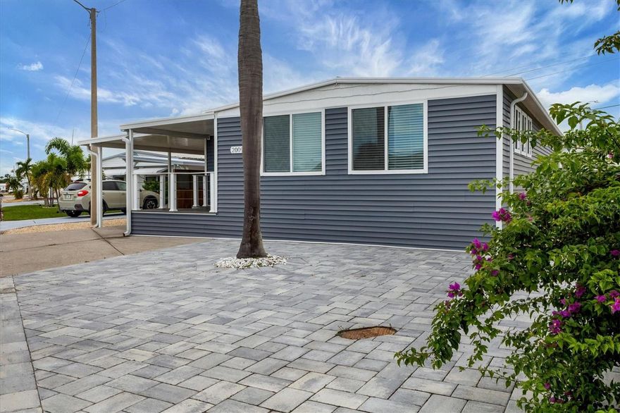 STUNNING COASTAL RENOVATION! This 3 Bedroom, 2 Bath Cottage-core Mobile Home is situated on an oversized Lot and a Half in the top-tier, active 55+ Trailer Estates community. The Open Concept and expansive living spaces are wonderful for entertaining, with vaulted ceilings and tons of natural light! 3rd Bedroom is currently set up as a bunk room, but could be great office space or den. Luxury vinyl plank floors throughout. Kitchen boasts a long center island for gathering with plenty of Shaker style cabinets, modern stainless steel appliances and a ton of quartz countertop space. Generous Primary Bedroom with wall to wall built-in closet. Roomy ensuite Primary Bath has walk-in shower and convenient Laundry space. Impact windows / doors. Huge backyard! Every square inch of the home has been thoughtfully designed to maximize a relaxed, laid back lifestyle. Highly effective, energy efficient spray foam insulation throughout the home. This home is low maintenance. A 7x7 shed for workshop or storage. You own the land. Boaters have direct access to Sarasota Bay from the Marina. Enjoy the large, heated community pool, hot tub, gym and wood shop. The community buzzes with pickleball, shuffleboard, kayaking, horseshoes, bocce, dancing and more. A US Post Office on site. 10 minutes to Sarasota-Bradenton Int'l Airport. Convenient to shopping, restaurants, the Arts and everything in Bradenton/Sarasota. Sold furnished.