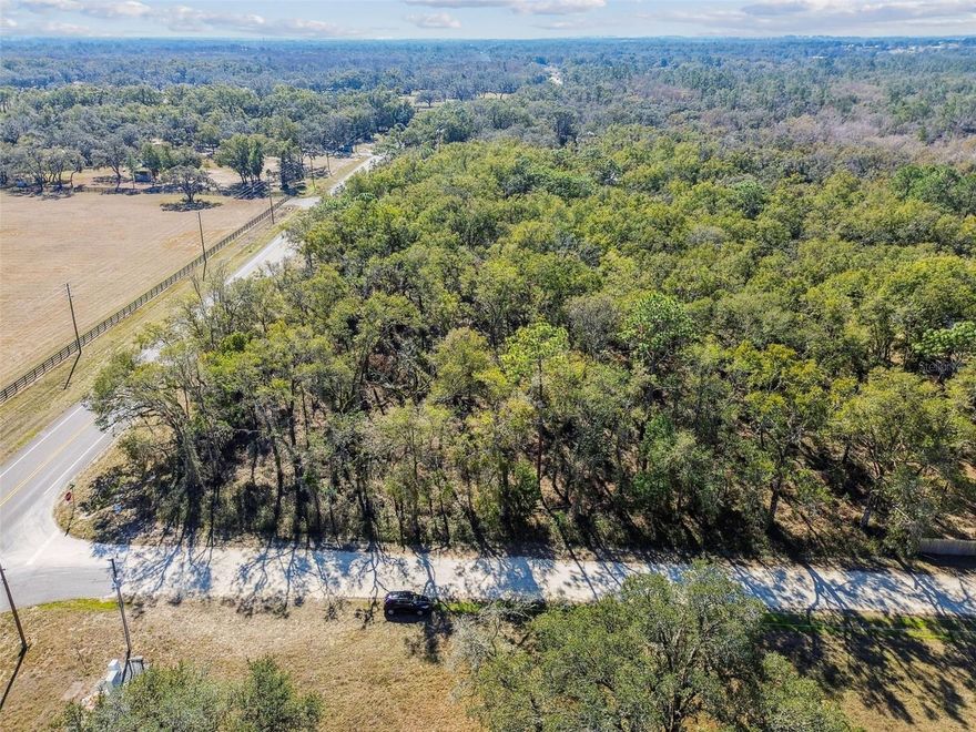 Prime 5-Acre Corner Lot in Dade City – Endless Possibilities in a Serene Setting, owner willing to subdivide!

Discover this exceptional 5-acre vacant parcel, perfectly situated on a corner lot in Dade City, part of Hernando County’s thriving and growing community. With its peaceful, wooded backdrop and unmatched versatility, this property presents an ideal opportunity for your dream development, whether it’s crafting a custom home, establishing a residential community, or creating a thriving business.

The prime corner location offers maximum visibility and easy access, making it perfect for residential or commercial development. The serene and secluded setting is surrounded by natural beauty, providing both privacy and a tranquil environment for any project. Conveniently positioned near major roadways, including I-75 for quick access to Ocala and Tampa, SR 50 toward Orlando, and US 98 leading to Lakeland, this property ensures accessibility without sacrificing its peaceful charm.

Outdoor enthusiasts will love the proximity to nearby attractions like Croom Wildlife Management Area and Withlacoochee State Forest, both just a short drive away, offering opportunities for hiking, fishing, horseback riding, and more. For water-based adventures, Withlacoochee River Park provides kayaking, canoeing, and small boat launches. The scenic Withlacoochee State Trail, leading to Inverness, is perfect for cycling and nature walks, while the Croom hunting preserve is also nearby for additional recreation.

This parcel offers incredible residential potential for building a custom home or developing a boutique residential community with access to local amenities and schools. Alternatively, the high visibility and proximity to a bustling commercial corridor make it an outstanding location for a successful business.

Don’t miss the chance to own this remarkable property, where natural charm, accessibility, and endless potential converge. Whether you’re seeking a peaceful place to call home or looking to invest in Dade City’s bright future, this land offers the perfect canvas to bring your vision to life.