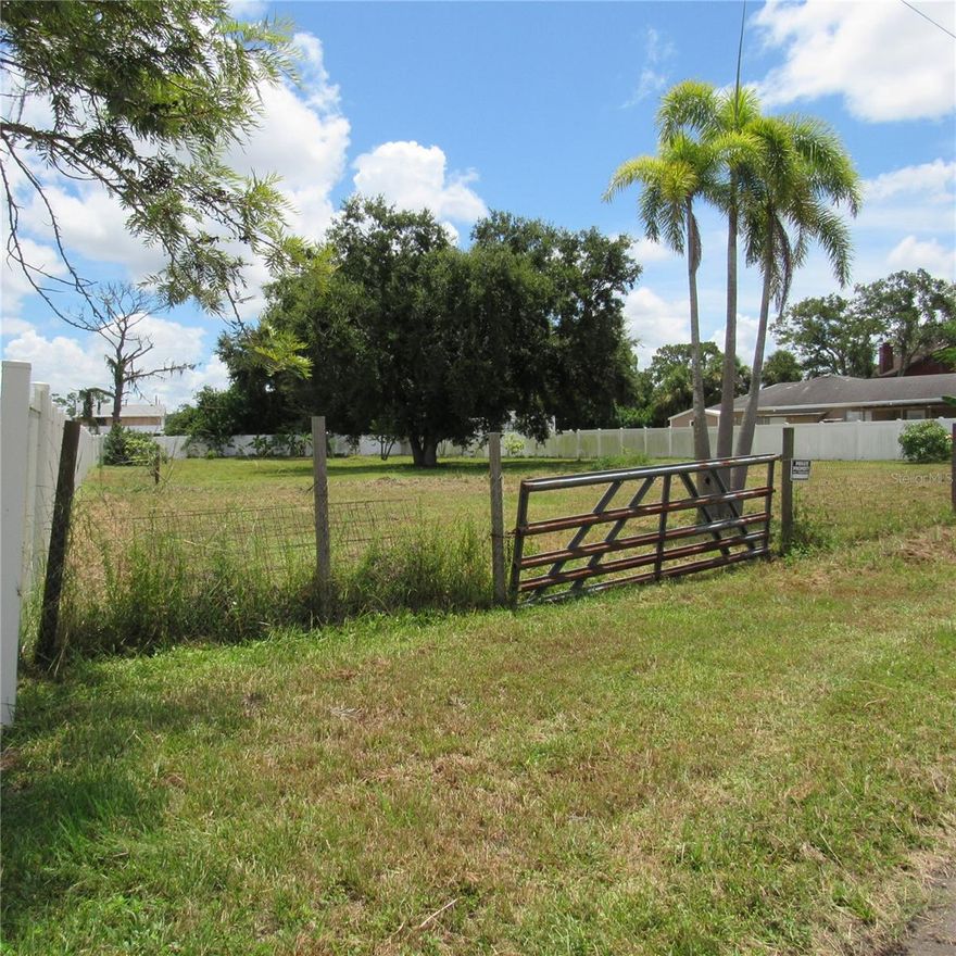 Discover this prime piece of vacant land, ready for your vision. Situated in a highly desirable location, this nearly half-acre lot offers the perfect blend of convenience and privacy—close to shopping, dining, schools, and major highways, yet tucked away in a peaceful setting. The property is fully enclosed with a durable, attractive vinyl fence, offering both security and aesthetic appeal. Utilities are nearby, and the lot is cleared and ready for immediate construction. Don’t miss this opportunity to create your ideal home in one of the area's most sought-after locations!