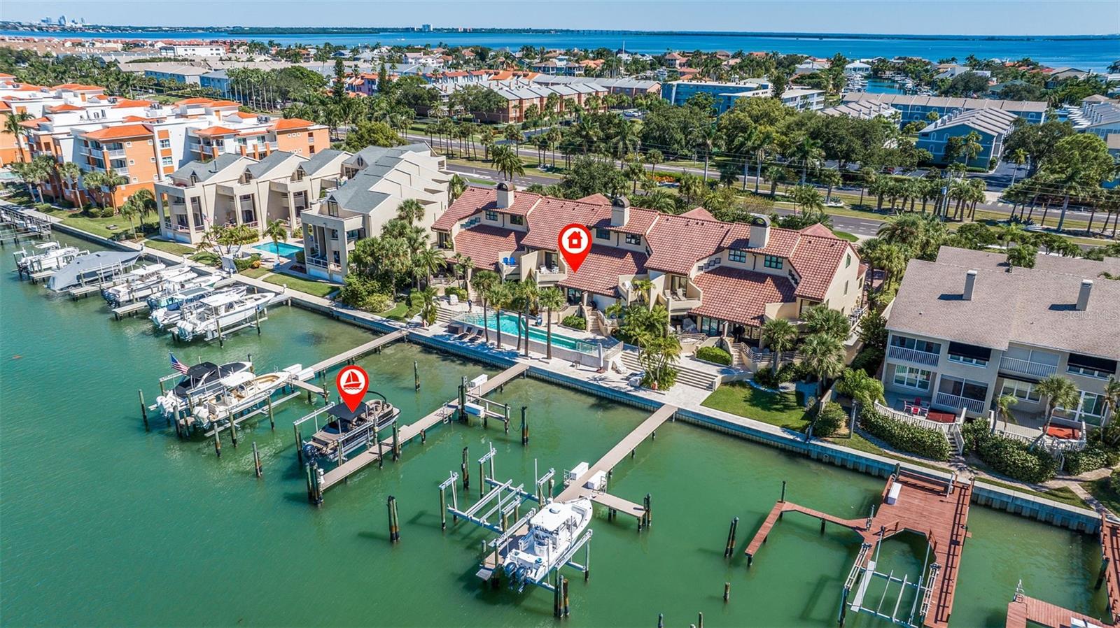 This exquisite 3200 SF waterfront multi-level residence, graced with an oversized boat slip on Tierra Verde's Grand Canal, redefines opulence in luxury coastal living. Nestled within the small, gated community of Mariah, it offers an intimate retreat for discerning residents seeking privacy, security, and convenience of instant access to boating, along with breathtaking sunset views.
As you step inside, abundant light and space welcome you, creating a sense of openness and warmth rarely found in townhome living. The layout has been thoughtfully designed, providing a true sense of home within these walls. The main level features an open-concept design that seamlessly combines the kitchen, dining, and living areas into a vast expanse of comfort and functionality. A contemporary coastal kitchen harmoniously melds with a living room, boasting high ceilings and elegant travertine flooring, a gas fireplace, and breathtaking water and sunset vistas from every angle of this living level. The soapstone countertops, finely crafted custom cabinetry, pantry cabinets, nearby laundry room, and upscale appliances complete this stylish kitchen - a space destined for entertaining and everyday moments. Expansive custom windows and sliding doors invite the waterfront ambiance to flow freely, offering quick and easy access to the spacious outdoor private patio, grill area, and lounge-ready lower pool deck. The second-level master suite is designed to elevate your comfort and indulgence. This generously proportioned high-ceiling sanctuary with walk-in closet boasts a freshly updated bathroom, with a circular shower offering a spa-like experience, while the standalone bathtub beckons for moments of pure relaxation. The bedroom's allure is heightened by sliding door access to a private-feel balcony. This intimate outdoor space provides a perfect point to savor the tranquil water views, creating an oasis of serenity within your home. The split floor plan with two guest bedroom suites on the opposite side ensures privacy with plenty of space, new upscale carpet, and walk-in closets. The top floor room features more fantastic views whether you decide to use it as a home office, yoga studio, or another guest room suite. This residence is modern yet ageless, austere yet sumptuous, and, above all, immensely effortlessly livable!
Boasting two separate garages - a single-car and a tandem - as well as options for additional parking, this residence caters to convenience. Within this exclusive pet-friendly gated community atmosphere, each residence enjoys the benefits of restricted access, ensuring a tranquil living experience. With an array of new hurricane-resistant windows and doors, this home offers a turn-key, hassle-free approach to savoring the finest that Tierra Verde provides, whether you're a full-time resident or a second-home owner. Positioned on the most coveted boating water along the Gulf Coast, it boasts an oversized boat slip with a 16k boat lift on deep, sheltered yet open waters, only a few minutes from the Gulf of Mexico, promising endless boating and water sport possibilities. Direct access to the Gulf and Intracoastal Waterway, only 10 mins to downtown St Petersburg by water or freeway. Nearby proximity to the pristine beaches of Pass-A-Grille & Fort DeSoto Park. Conveniently located within 40 mins to TPA, PIE, or SRQ.