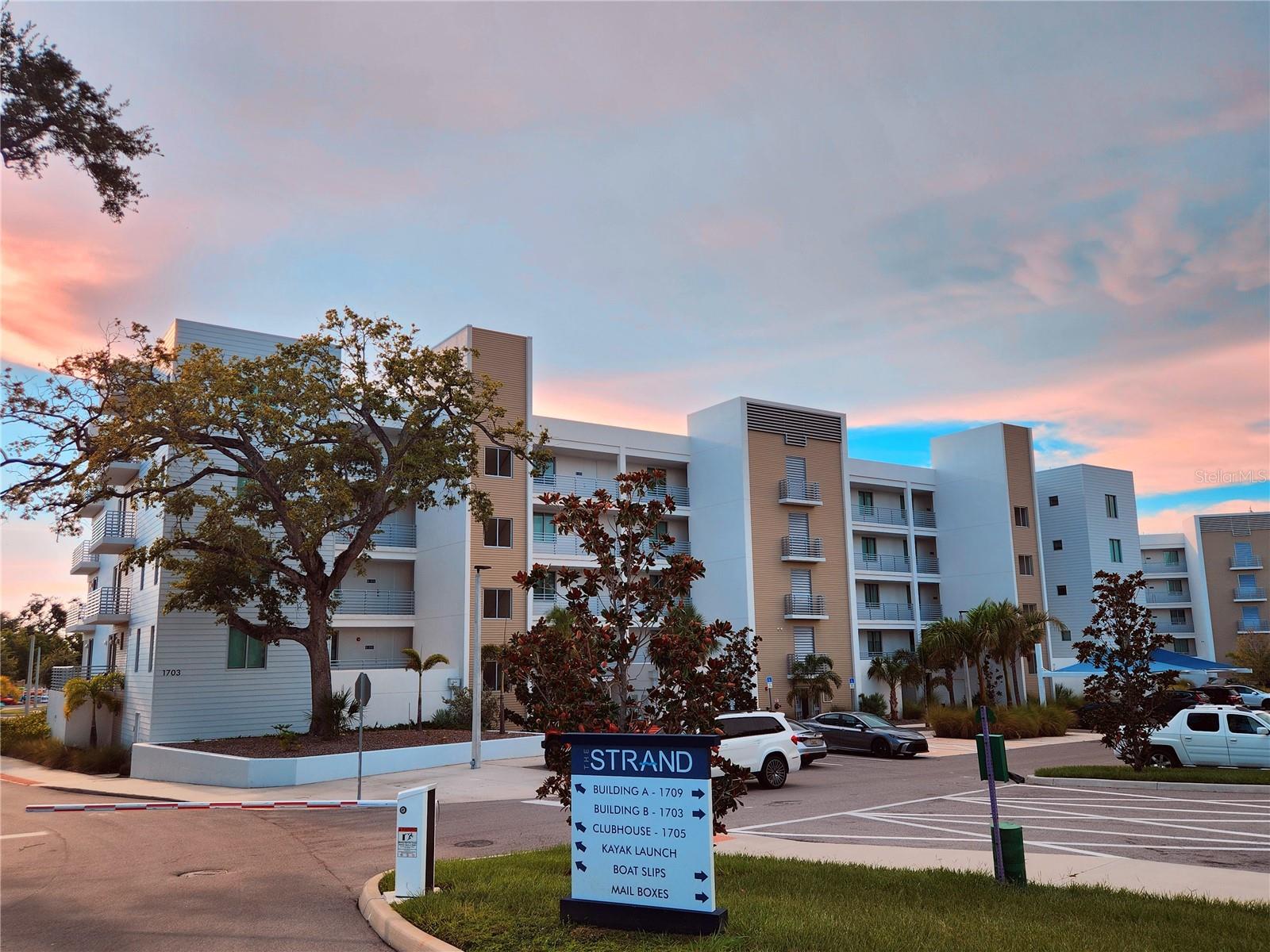 Welcome Boaters! This is your opportunity to own a top floor unit with peekaboo bay views and your own private dock at The Strand! Unit 507 offers the rare opportunity of an included deeded 32.5ft private dock with water and electric. After boating you can enjoy a beautiful sunset on your covered terrace with peekaboo bay and pool views. The large kitchen quartz counters and open floor plan make this condo great for entertaining. The primary suite offers a large walk in shower and walk in closet. The den offers a closet, making it a perfect room for guests. The Strand offers a private dog park, floating kayak launch, pool and spa, gym, fire pit, and gas grills. All of this is located a short distance to 3 waterfront public parks, a 2 minute drive to downtown for weekend farmer's markets or an evening opera show. Lido Key beach is only 5 miles and the world famous Siesta Key is only 8 miles from your private garage parking spot.