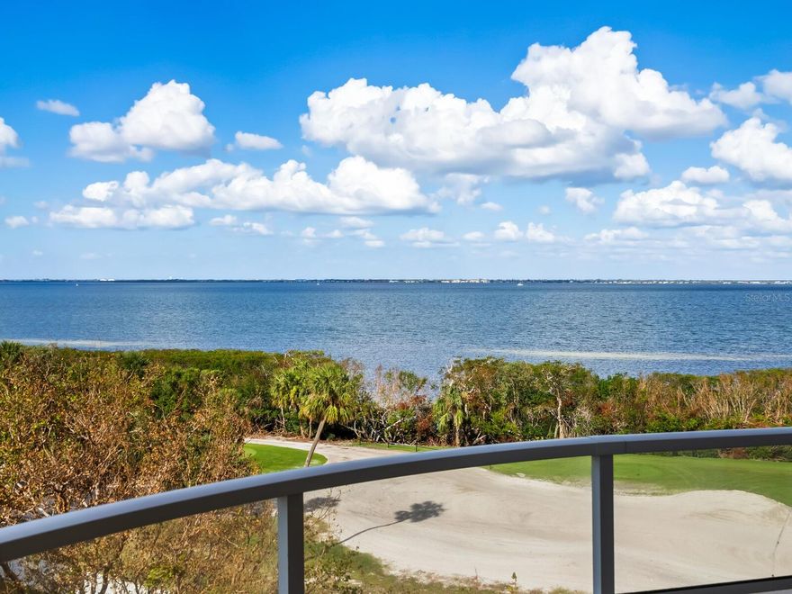 Move in ready and beautifully updated two bedroom two bath Bimini model in Grand Bay nestled within the secure gated enclave of Bay Isles. Located on the third living level of the four level over parking building 6, you will enjoy panoramic views of Sarasota Bay as you gaze out from your almost 400 foot wrap around terrace. This particular condo has been tastefully updated with new HVAC with Wi-Fi thermostat in 2024; new refrigerator, washer & dryer, Hunter Douglas battery operated remote-controlled window treatments, lighting & plumbing fixtures & freshly painted all in 2023.  Nothing more to do but to move in and enjoy everything Grand Bay, Longboat Key and Sarasota have to offer! Your amenities include two large resort style heated swimming pools and spas, tennis courts, state of the art fitness center and expansive clubhouse with social activities as well as access to the private white sandy well maintained beach at the Bay Isles Beach Club on the Gulf of Mexico. You will also have access to beautiful peaceful walking trails winding along the bay front, marina and golf courses. A short drive will lead you to choice eateries along Gulf of Mexico Drive or over the bridge to St Armands Circle and downtown Sarasota.