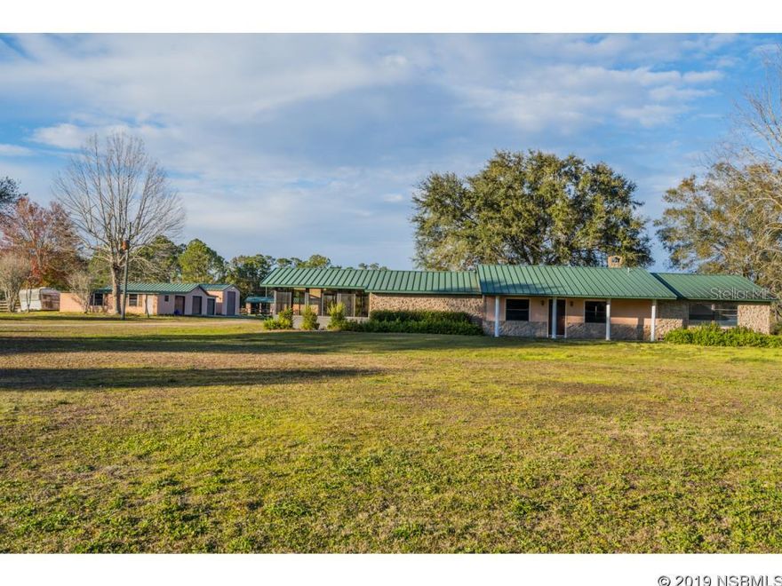5 CLEARED ACRES FENCED FOR HORSES, LOTS OF OUT BUILDINGS AND BARNS, ALL WITH METAL ROOFS THAT MATCH THE MAIN HOME, 1 ACRE SPRING FED POND WITH BASS AND PLENTY OF WATER FOR YOUR HORSES, LOTS OF CORRALS, MAIN HOME IS 3,070 SQFT WITH 3 BEDROOMS AND 3 FULL BATHS, ANOTHER FULL BATH IN ONE OF THE GARAGES, 5,000 SQUARE FEET OF ADDITIONAL GARAGES AND WORKSHOPS OF WHICH 2,500 SQFT ARE UNDER AIR, ON A PAVED ROAD, IF YOU LOVE HORSES THIS IS THE HOME FOR YOU. IF YOU LOVE THE BIG OUTDOORS, FISHING AND HAVING LOTS OF OUT BUILDINGS THIS IS FOR YOU TOO.