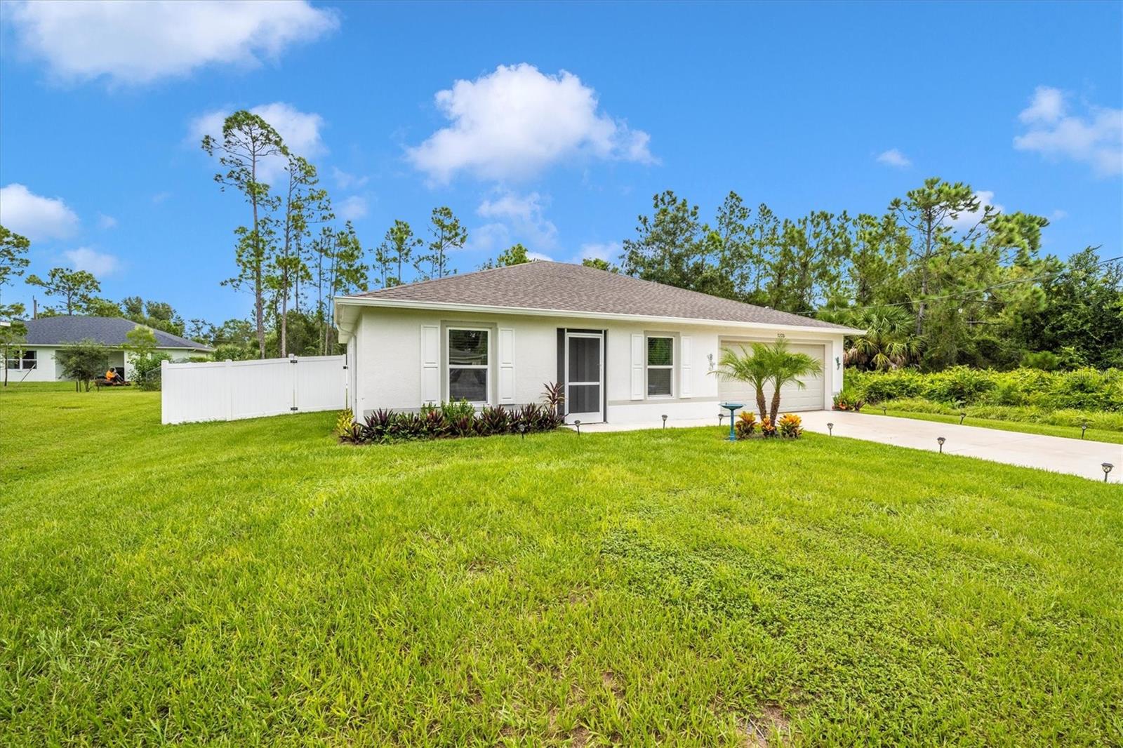 Just East is North Port ESTATES, a desireable location. Only 1 1/2 years old. MOVE RIGHT IN AND START LIVING! Everything has been done for you. Built in 2023 by Holiday Builders, this thoughtfully designed 3-bedroom, 2-bath home with hip roof offers the perfect blend of modern style and everyday comfort. Enjoy the double Pygmy Date Palm and the statement Bismark Palm and all of the flora in the front yard. The lawn fully grown; no waiting and weeding for a year after your new build. Screened front entrance allows you to enjoy the breeze from front to backstep. Step inside the foyer to an open-concept floor plan filled with natural light, featuring a spacious living area that flows seamlessly over a breakfast counter for up to four stools into the kitchen - ideal for conversations while cooking. Brushed nickel knobs and handles installed in kitchen and bathrooms. Attached Dining Room for full size table and large windows. 4 Fans installed with dimmers on the living room and bedroom. Cordless Shades installed on windows. The split-bedroom layout ensures privacy, with a generous owner’s suite complete with a walk-in closet and en-suite bath. Towel rods, hooks and tissue holders already installed.
Enjoy the convenience of a 2-car garage, durable concrete block construction, and energy-efficient design for peace of mind. Backyard has Privacy Fence with two 6ft gates and lighted posts. Septic and Well with water filtration and softener system recently serviced and new GFI installed. Air Conditioner recently serviced and contract conveys until February 2026. Water Heater recently checked and no problems found . Garage Door Opener already installed with 2 remotes. Drawers and Work Station in the garage will stay at buyers request. This lot has culvert added so no ditch in front yard and the culvert extends all the way across the front yard so you won't have to deal with a muddy swale for 6 months every year. Comes complete with mailbox, start forwarding your mail here!
Located in the desirable North Port community, this home is just minutes from shopping, dining, schools, and easy access to I-75—offering both tranquility and convenience. For work-life balance, this is the home for you! ROOM FOR A POOL!! NO HOA!!