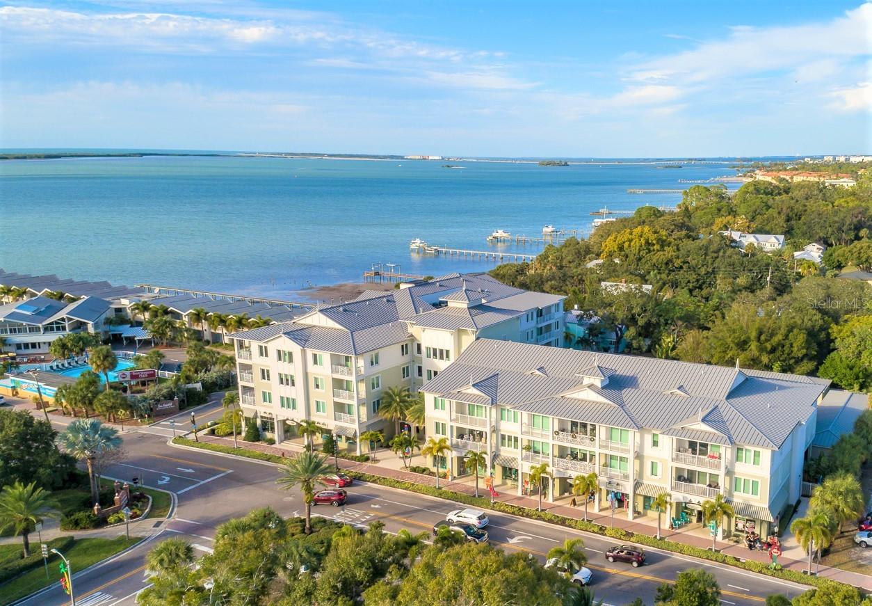 The Epitome of LUXURY Living in the HEART OF DOWNTOWN DUNEDIN, this stunning 2016 condominium residence by award-winning builder JMC Communities offers Sophisticated COASTAL ELEGANCE and superior craftsmanship. Located in the exclusive Victoria Place, a BOUTIQUE 30-UNIT community with retail below, this residence features a desirable split-bedroom floor plan with two spacious suites separated by the Grand Salon, living and dining area, and a GOURMET KITCHEN adorned with Quartzite countertops, a walk-in pantry, Jenn-Air appliances including a GAS RANGE, a stainless steel farm sink, and custom cabinetry. Soaring 9’6” CEILINGS, crown molding, top-quality engineered hardwood flooring, 8' glass sliders, recessed lighting, ceiling fans, and custom-built-ins elevate the living experience throughout. SAFE, SECURE and ELEVATED built to the highest standards with HURRICANE-rated WINDOWS and DOORS, gated under-building parking, secured perimeter access, and no reported storm damage, Victoria Place also boasts energy-efficient systems, including gas hot water and a community-wide water softening system. This unit includes TWO ASSIGNED PARKING SPACES (#24 & #34), one covered, and a CLIMATE-CONTROLLED STORAGE room. Monthly fees cover water, sewer, natural gas for hot water, gas range, and dryer, trash, cable, internet, building insurance, reserves, exterior maintenance, and management. PET-FRIENDLY 2 pets with a 40 lb. limit and rental-restricted to three units at a time with a one-year minimum lease (confirm with HOA) the building promotes a strong sense of community, primarily consisting of full-time residents. Enjoy Dunedin’s vibrant lifestyle with WALKABLE ACCESS to the marina, parks, fine dining, breweries, boutiques, wine bars, salons, farmers markets, art shows, parades, live music, and even a healthy grocery store—just steps from your door. RIDE YOUR BIKE on the Pinellas Trail, spend a day at the BEACH on Honeymoon Island, take a stroll along the Causeway, or watch a Waterfront Sunset from the Marina, there are so many choices! Come Live in Downtown Dunedin—Come Live the Lifestyle!
