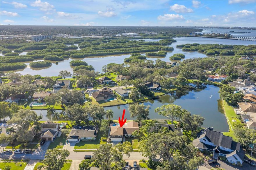 One or more photo(s) has been virtually staged. Where golf community living meets lakeside retreat… all just a short drive to the beautiful Gulf beaches. Now is your chance to secure a slice of the esteemed Seminole Lake Country Club Estates golf community with this almost half-acre property on the serene Baywood Park Lake. The updates have already been done for you, including a $20,000 luxury Savant home automation system that transforms a regular house into an entertainer’s delight with the touch of a button, featuring indoor and outdoor speakers, security cameras, and endless opportunities for further smart home integration throughout the home. The home underwent massive renovation from 2023-2025, including but not limited to the beautifully updated kitchen and bathrooms, flooring throughout, pool resurfacing, new paver deck, and fresh exterior paint. Ask for the list of updates and features… there are simply too many to list! And for added peace of mind, seller says the home did not experience any damage or water intrusion from Hurricanes Helene & Milton! The flexibility in the spacious first level floor plan provides countless opportunities for designing a layout that works for your specific needs, excellent for hosting large gatherings or anyone wanting separate spaces. The kitchen boasts a massive island for additional bar seating and storage, stainless steel appliances, quartz counters, and a coffee bar. The lakeside great room with its vaulted ceilings and picturesque views allow natural light to pour in… designing your dream bonus area here will be a cinch. The expansive primary bedroom wing located on the first floor has a dreamy en-suite bathroom and walk-in closet. On the other side of the first floor is an indoor laundry room, the half bath, as well as a bedroom currently with built-in desk space for an office, homework or crafting room… again, you name it! The remaining three bedrooms are upstairs with an abundance of closet spaces and a beautiful hall bathroom. Two sets of French doors lead to the screened-in patio, where you can relax and unwind lakeside as you sip your morning coffee or evening libations. Finally, the fenced-in updated pool and spa invite you for a dip year-round thanks to the heater. Other substantial updates include new roof (2021); upstairs HVAC (2023); pool pump, heater, and chlorinator (2024/2025). Just blocks away, the Seminole Lake Country Club offers membership access to golf, tennis, pickleball, and club restaurant and activities. The opportunity to own a home of this stature in a neighborhood of this caliber is rare; don’t let it slip through your fingers.