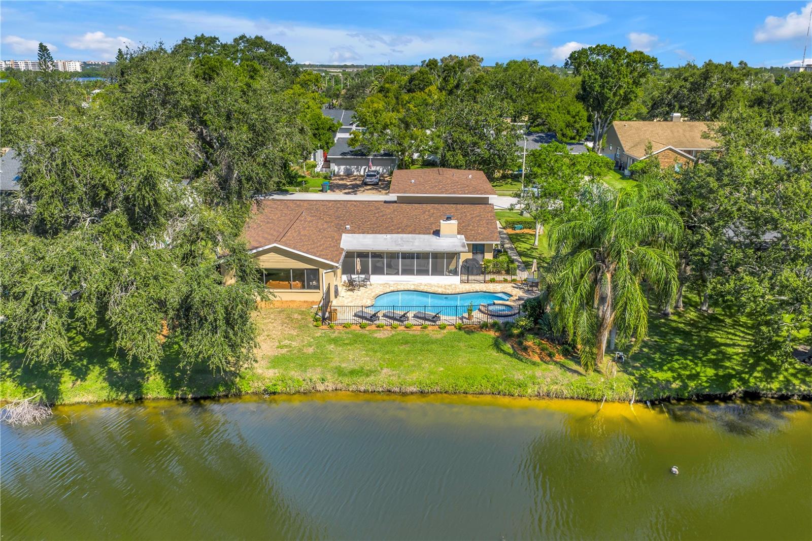 Where golf community living meets lakeside retreat… all just a short drive to the beautiful Gulf beaches. Now is your chance to secure a slice of the esteemed Seminole Lake Country Club Estates golf community with this almost half-acre property on the serene Baywood Park Lake. The updates have already been done for you, including a $20,000 luxury Savant home automation system that transforms a regular house into an entertainer’s delight with the touch of a button, featuring indoor and outdoor speakers, security cameras, and endless opportunities for further smart home integration throughout the home. The home underwent massive renovation from 2023-2025, including but not limited to the beautifully updated kitchen and bathrooms, flooring throughout, pool resurfacing, and new paver deck. Ask for the list of updates and features… there are simply too many to list! And for added peace of mind, seller says the home did not experience any damage or water intrusion from Hurricanes Helene & Milton! The flexibility in the spacious first level floor plan provides countless opportunities for designing a layout that works for your specific needs, excellent for hosting large gatherings or anyone wanting separate spaces. The kitchen boasts a massive island for additional bar seating and storage, stainless steel appliances, quartz counters, and a coffee bar. The lakeside great room with its vaulted ceilings and picturesque views allow natural light to pour in… designing your dream bonus area here will be a cinch. The expansive primary bedroom wing located on the first floor has a dreamy en-suite bathroom and walk-in closet. On the other side of the first floor is an indoor laundry room, the half bath, as well as a bedroom currently with built-in desk space for an office, homework or crafting room… again, you name it! The remaining three bedrooms are upstairs with an abundance of closet spaces and a beautiful hall bathroom. Two sets of French doors lead to the screened-in patio, where you can relax and unwind lakeside as you sip your morning coffee or evening libations. Finally, the fenced-in updated pool and spa invite you for a dip year-round thanks to the heater. Other substantial updates include new roof (2021); upstairs HVAC (2023); pool pump, heater, and chlorinator (2024/2025). Just blocks away, the Seminole Lake Country Club offers membership access to golf, tennis, pickleball, and club restaurant and activities. The opportunity to own a home of this stature in a neighborhood of this caliber is rare; don’t let it slip through your fingers.