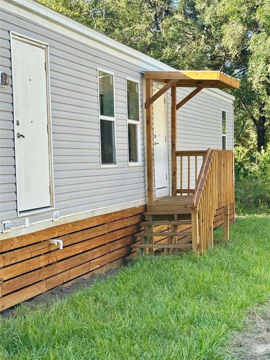 VA FINANCING NOW CONFIRMED — Modern 3BR/2BA Accessible Manufactured Home with Fire Suppression & Private Utilities — Move-In Ready! A rare opportunity just got even better — this upgraded and permanently installed 3-bedroom, 2-bath manufactured home is now FHA-eligible, making homeownership more accessible and affordable for qualified buyers. Located just outside Williston, minutes from the World Equestrian Center, Gainesville, and UF, this like-new property blends safety, efficiency, and long-term value in a peaceful country setting with NO HOA. Originally part of FEMA’s advanced-design housing program, this home offers far superior construction and safety features compared to typical mobile homes — including a full fire suppression sprinkler system, self-contained HVAC for cleaner air and simplified service, and true wheelchair accessibility with wide doorways and barrier-free design throughout.

Inside, the home features an open-concept layout, brand-new appliances including washer/dryer, upgraded finishes, and thoughtfully designed living spaces ready for immediate full-time use or long-term rental income. Outside, you'll find a fresh asphalt driveway, pressure-treated porches, and brand-new well and septic systems — all newly installed and permitted. 

Key Advantages:
NOW VA APPROVED — HUGE financing opportunity
Fully wheelchair accessible throughout
Integrated fire sprinkler system for added safety & insurance benefits
Self-contained HVAC system for low maintenance & improved indoor air quality
No HOA, low taxes, and flexible use potential — ideal for primary occupancy or rental portfolio
Minutes to WEC, Gainesville, UF, top hospitals & shopping
Homes like this — VA-eligible, safety-enhanced, no-HOA, country feel with city access — almost never hit the market.
Act quickly — rare VA-qualified second-set manufactured home with high-end safety and accessibility features won’t last. Seller open to, conventional portfolio, and possible owner financing.
